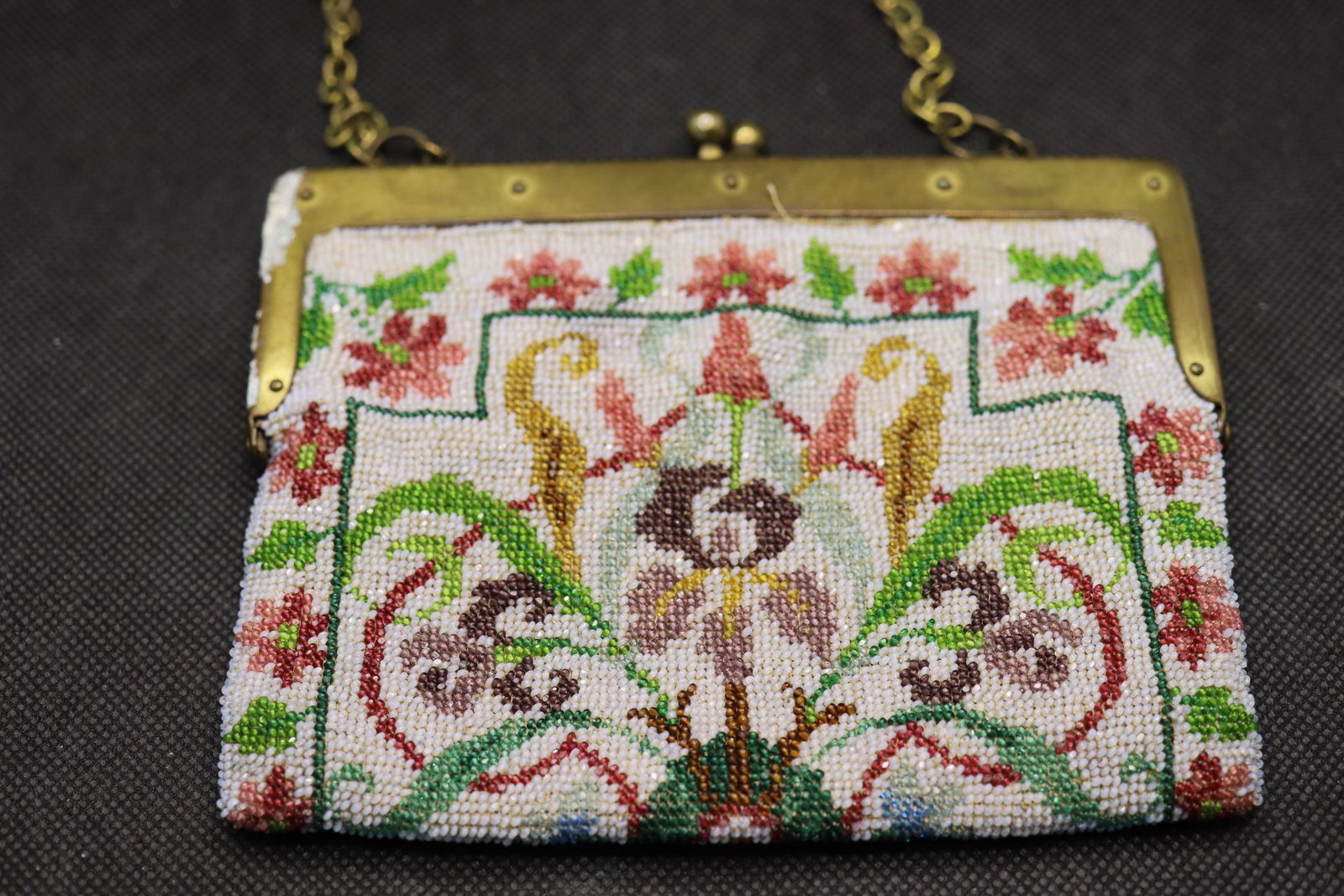 Antique Hand Beaded Purse, with original pattern: gold tone frame and chain has some discoloration, exceptional beaded bag with original paper pattern inside, see photo's for damage to one side, approx. 5 3/4 wide x 5 inches tall
