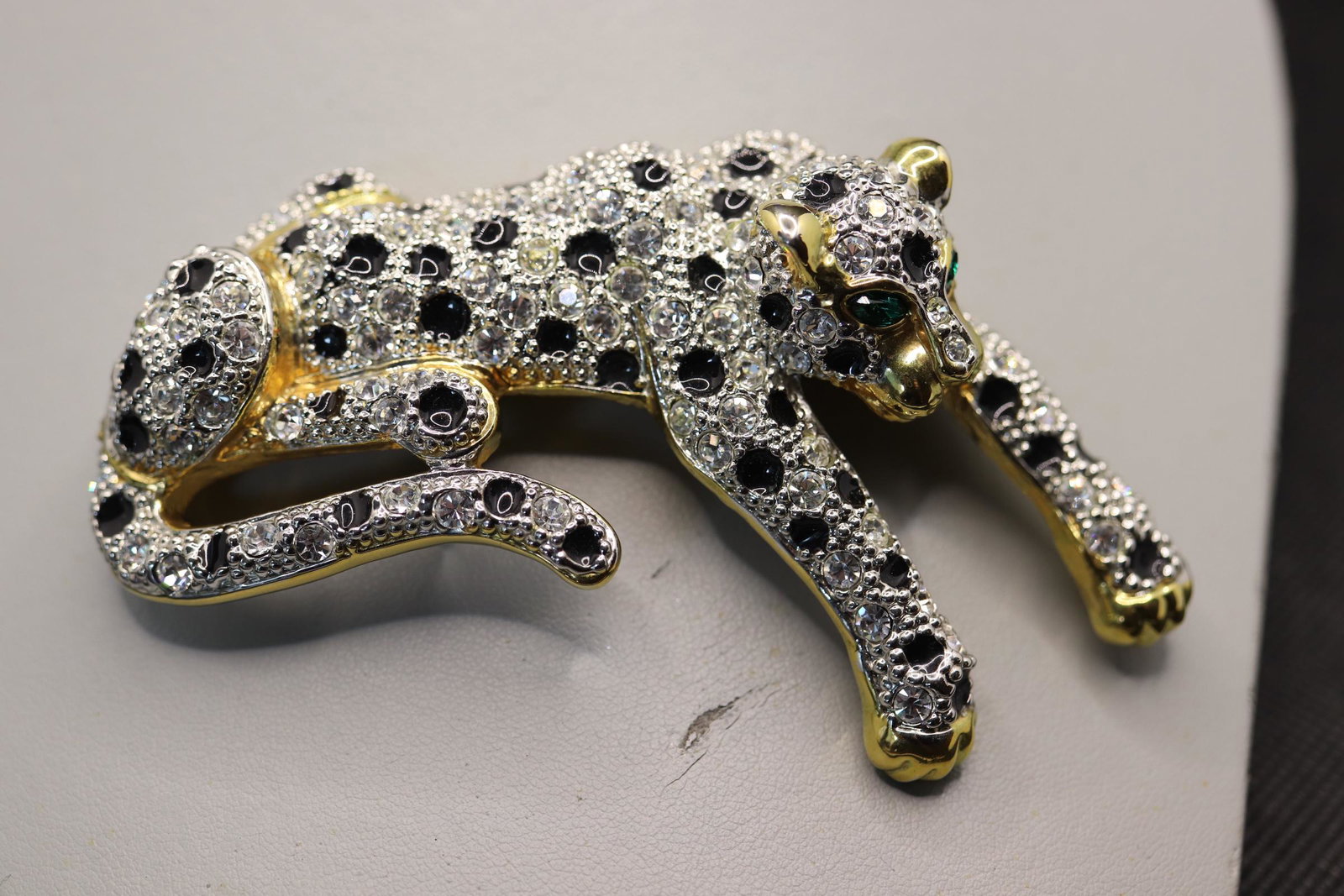 Vintage Crystal Rhinestone Leopard Brooch: large gold tone with clear rhinestone crystals and green stone eyes, approx. 3 1/2 long x 2 1/2