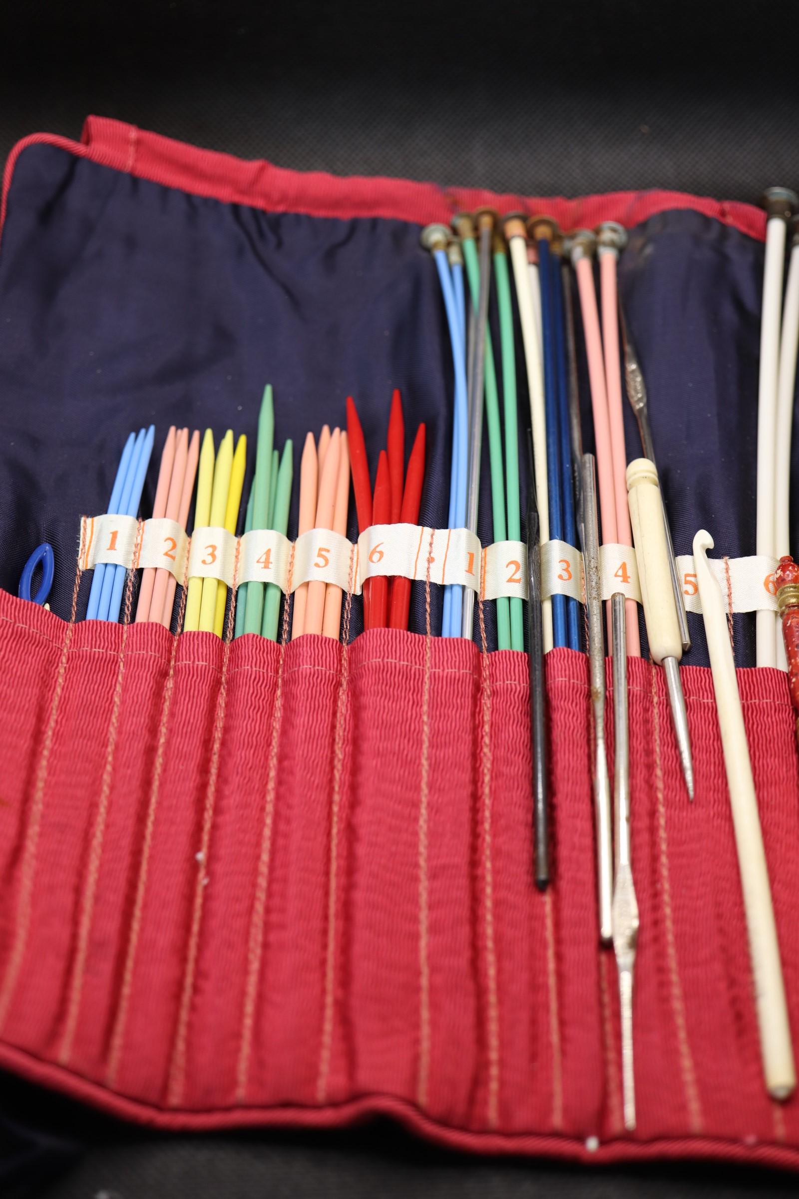 Large Lot of Knitting Needles & Crochet Hooks: red fabric carring case with different sizes, some loose crochet hooks and 2 bone sewing tools
