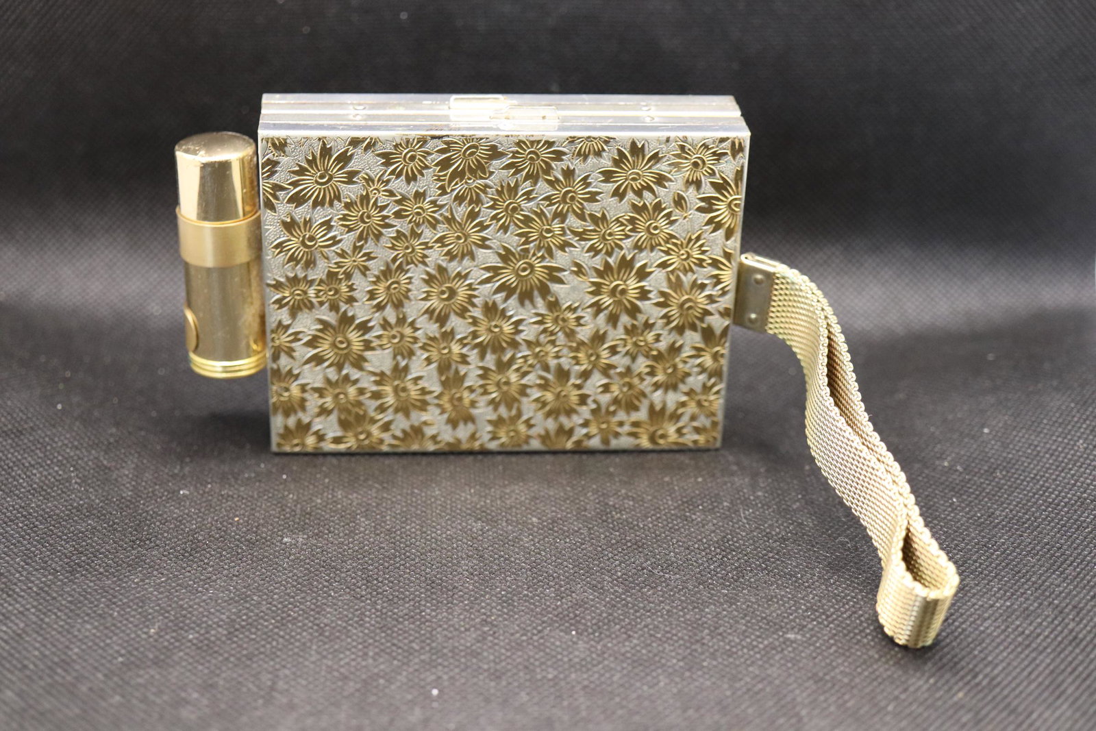Vintage Wristlet Makeup/Cigarette Case with Lipstick: first compartment has mirror, original comb, powder compact and small bag, lipstick case is mounted to side, and second compartment is for cigarettes, has wristlet mesh metal strap, daisy etched desig