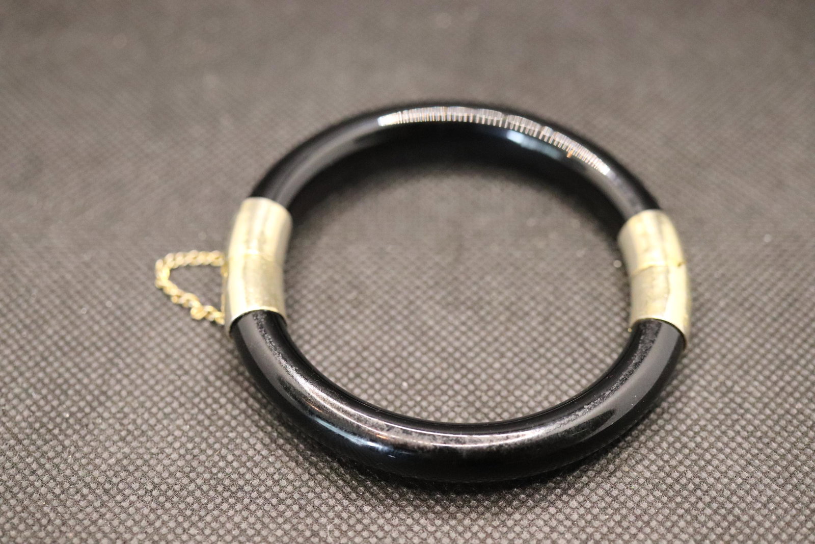 Vintage Black Jet Bangle Bracelet: black jet or Jade bangle with gold tone gclasp and safety chain, approx. 3 inches
