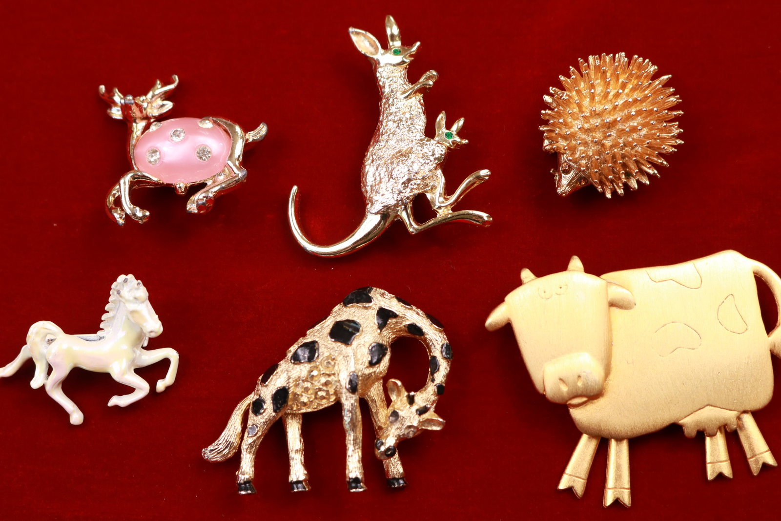 Vintage Animal Pin Brooch Lot including Deer with Jelly: Six charming vintage animal pins to include signed cow pin "JJ", Jelly Belly leaping stag with rhinestones, white iridescent horse, bent over giraffe, adorable Sarah Coventry hedgehog and a kangaroo w