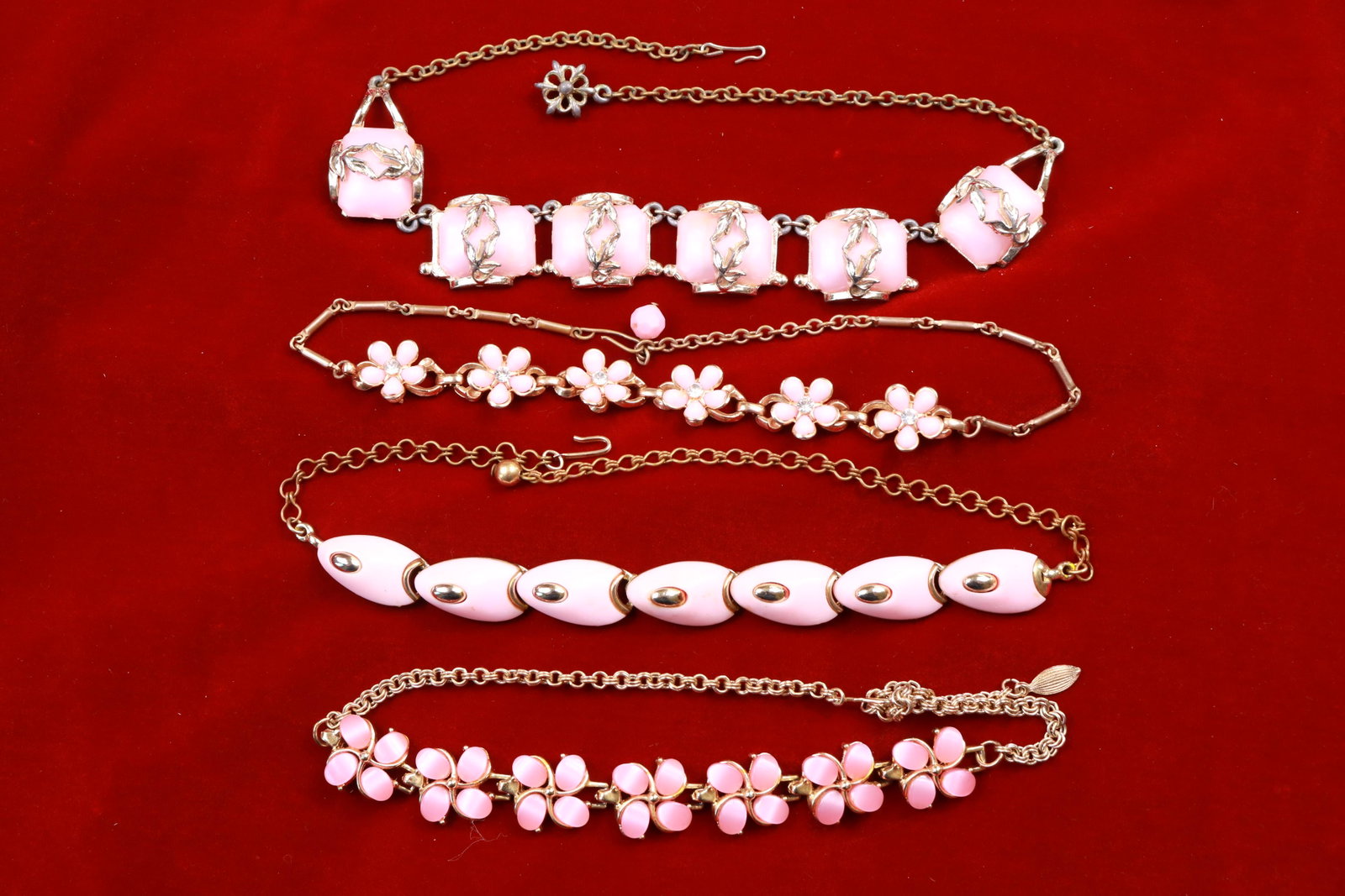 Vintage Pink Necklace Lot: When you're feeling "in the pink" one of these choker style vintages necklaces would be perfect! They measure between 15" - 16" in overall length. Love the rhinestone detail on the flower choker.