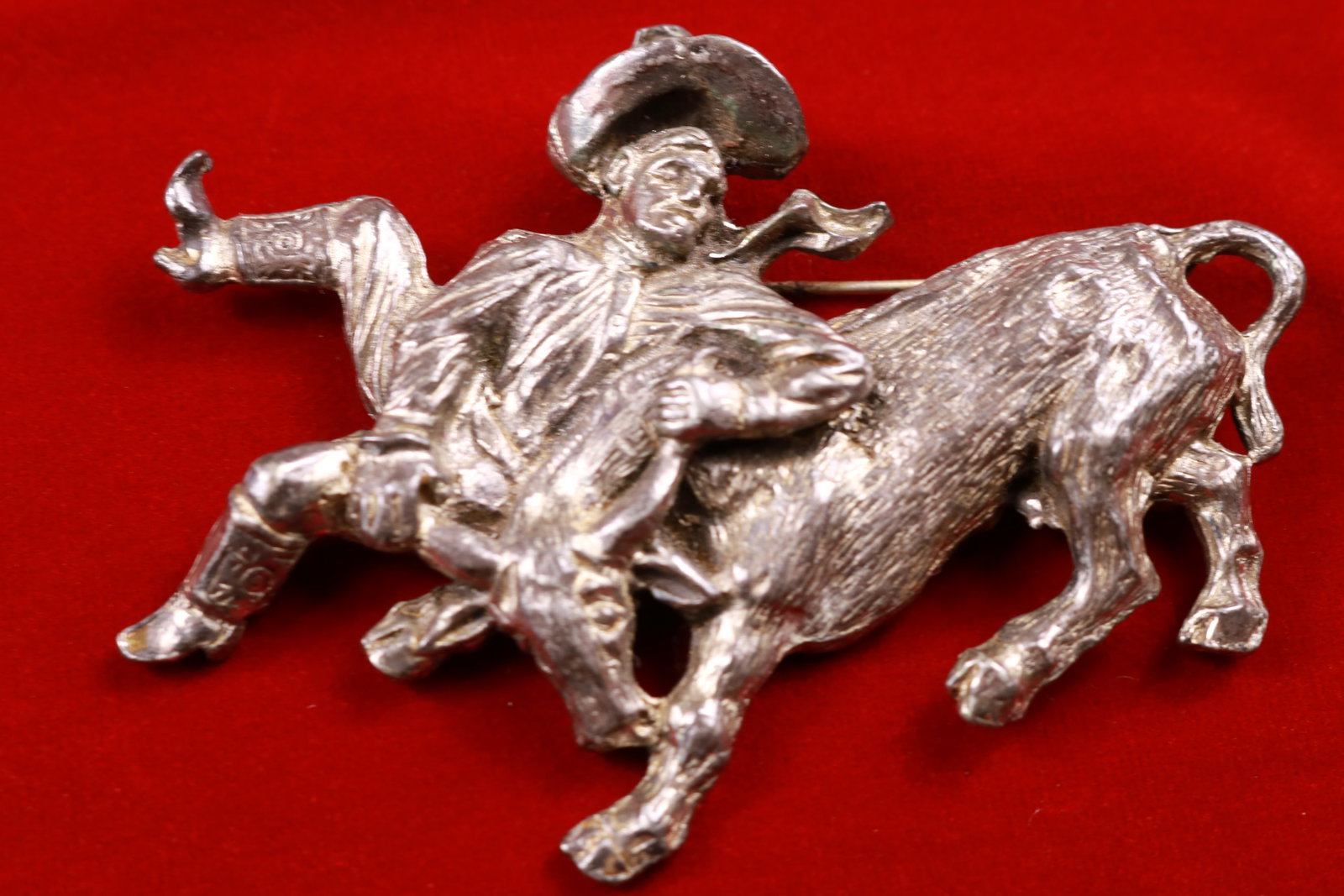 LARGE Vintage Cowboy Wrangling a Steer Pin / Brooch: This figural pin is a real show stopper. The detail in the face and the cowboy boots flailing really bring you straight to the rodeo. This piece measures 3.5" wide and about 2.5" tall. Great piece!