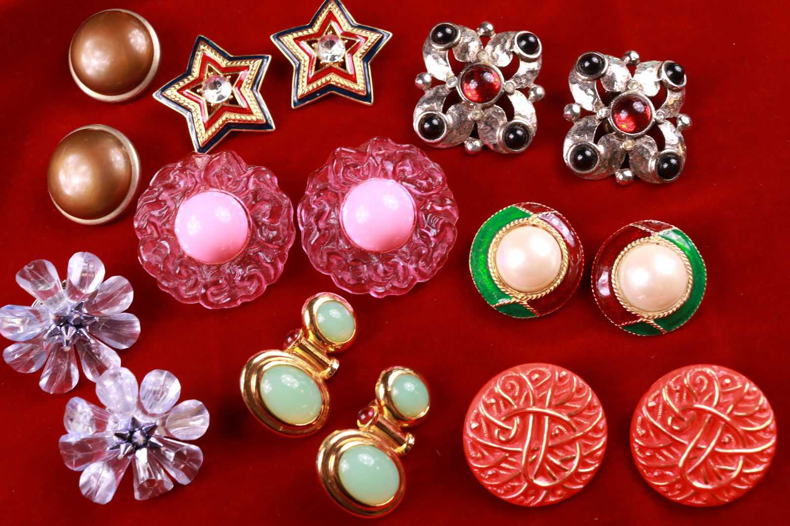 Vintage Clip-On Earring Lot CORO Trifari Gay Boyer: Great lot of the names you love to collect and all in excellent condition. The large orange pair are glass. Large plastic pink flowers measure nearly 1.75".