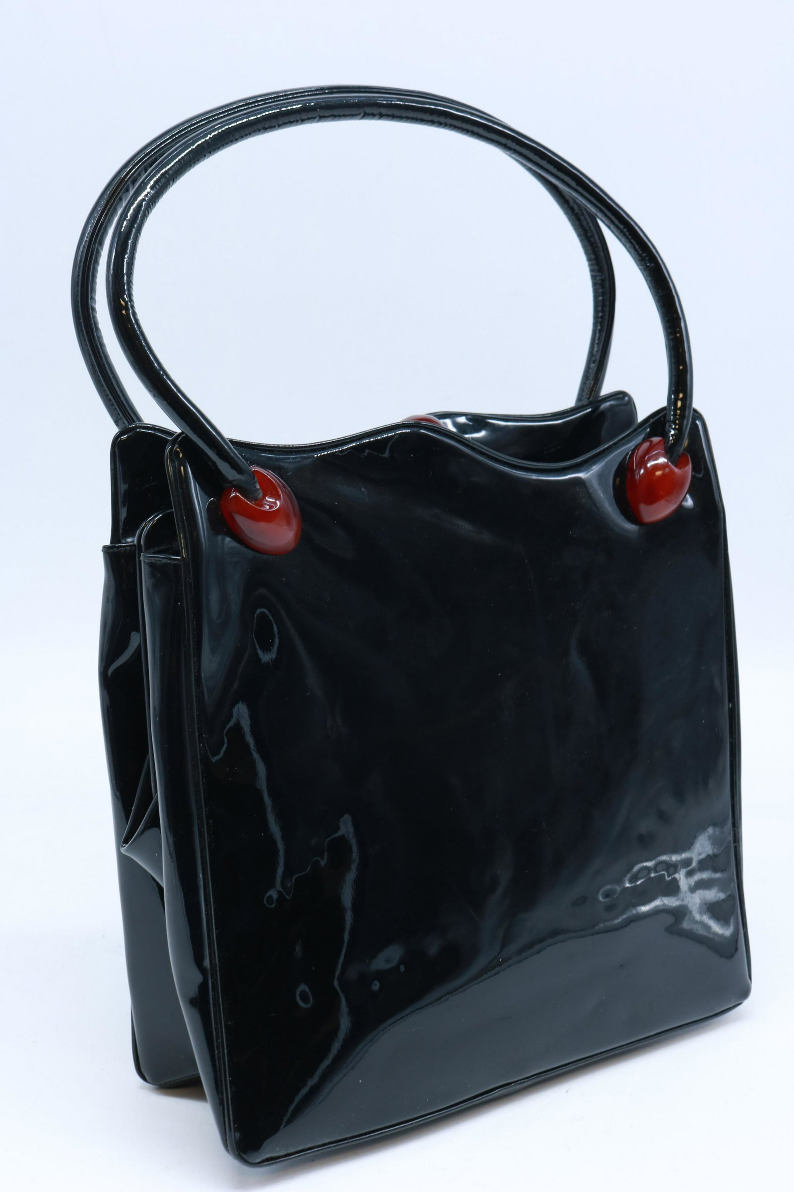 Vintage Holzman Black Patent Leather Handbag Purse: This bag is designed with bakelite/lucite accents at each handle base and the round fob that opens the center compartment. Bag measures 8.5" x 9" x 3". Black satin lining is in perfect condition.