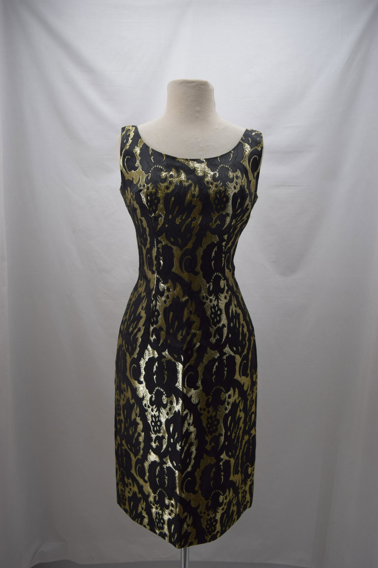 1960'S FERMAN-O'GRADY BLACK AND GOLD DRESS: BUST 36 WAIST 28, metallic woven design on black satin, sleeveless body con, small seam stress in back towards bottom, nice condition