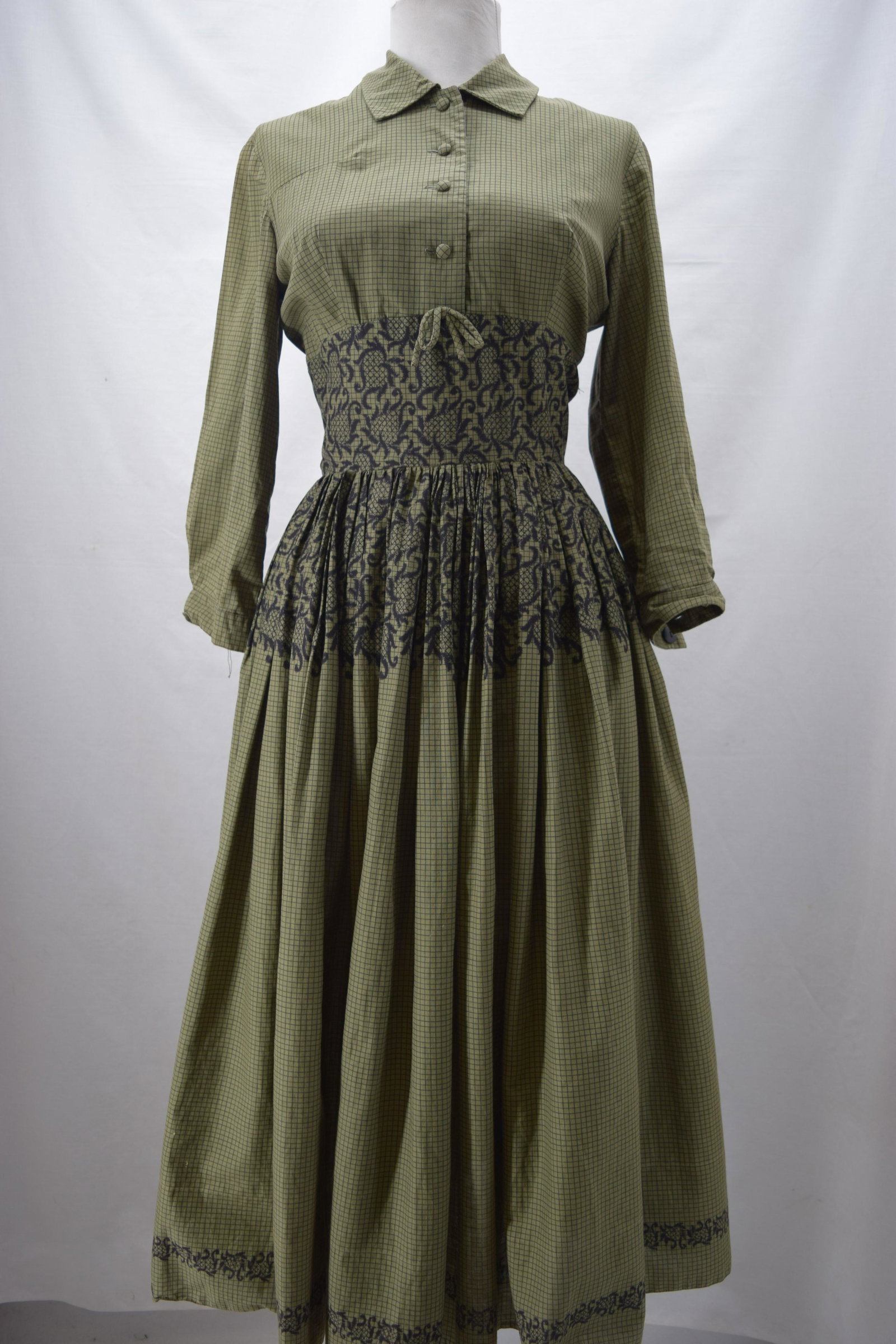 Vintage 1940/50's Green Check Cotton Pouf Dress: 3/4 sleeves, button front, wide band at empire waist with lace print detail, full gathered skirt, back zipper, approx. 34 bust, 24 waist, buttons missing from sleeve cuffs, faint underarm discoloratio
