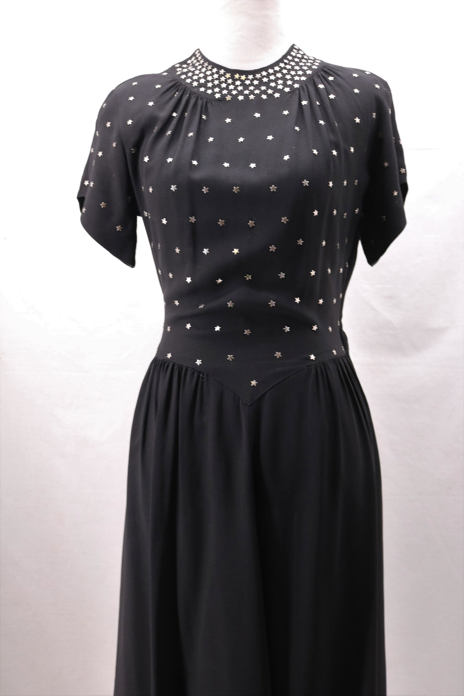 Vintage 1940's Star Studded Black Rayon Dress: round neck, padded shoulders, short sleeves, silver star studded bodice and neckline, gathered in front at waist, great traditional 40's design, side zipper, needs seam repair at underarms, and has so