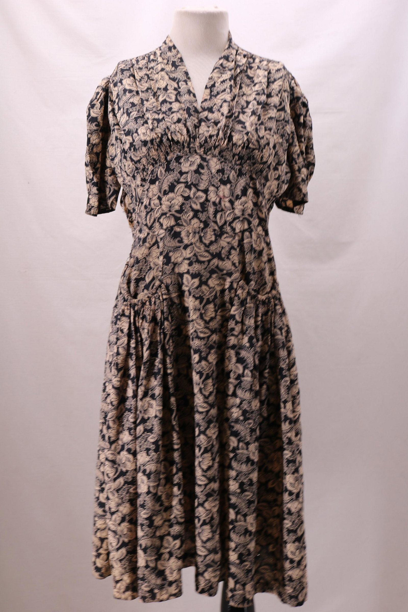 Vintage 1940's Tradition Black Floral Rayon Dress: smocked shoulders, short pinch pleated sleeves, V-neck with snap, smocked high waist with wide panel, gathered draped front pockets, slip on style, needs seam repair, some stains, see photo's, approx.