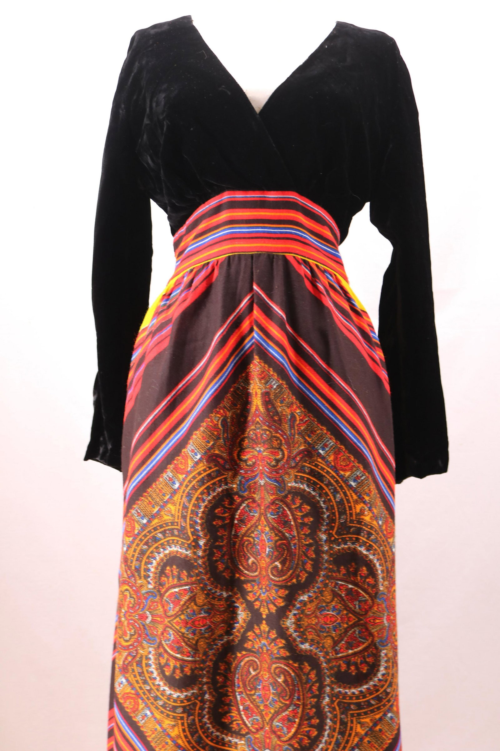 Vintage 1970's Black Velvet & Stripped Paisley Print: long black velvet sleeves with wrap style front, stripped band at empire waist that ties in back, gathered free flowing maxi skirt, diamond stripped cotton jersey fabric with paisley design, back zipp