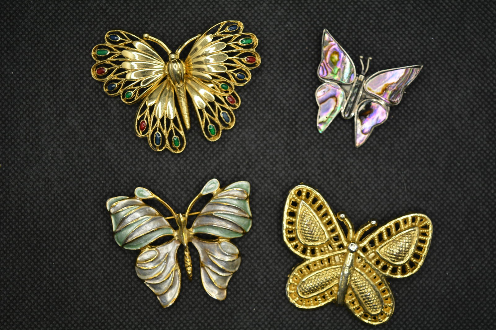 Vintage Butterfly Pin Brooch Lot Enamel/Abalone/Alpaca: Four butterfly pins. The "peacock" butterfly is articulated. The abalone butterfly is marked Mexico/Alpaca. The other two are not marked. The largest measures 2.5" across.