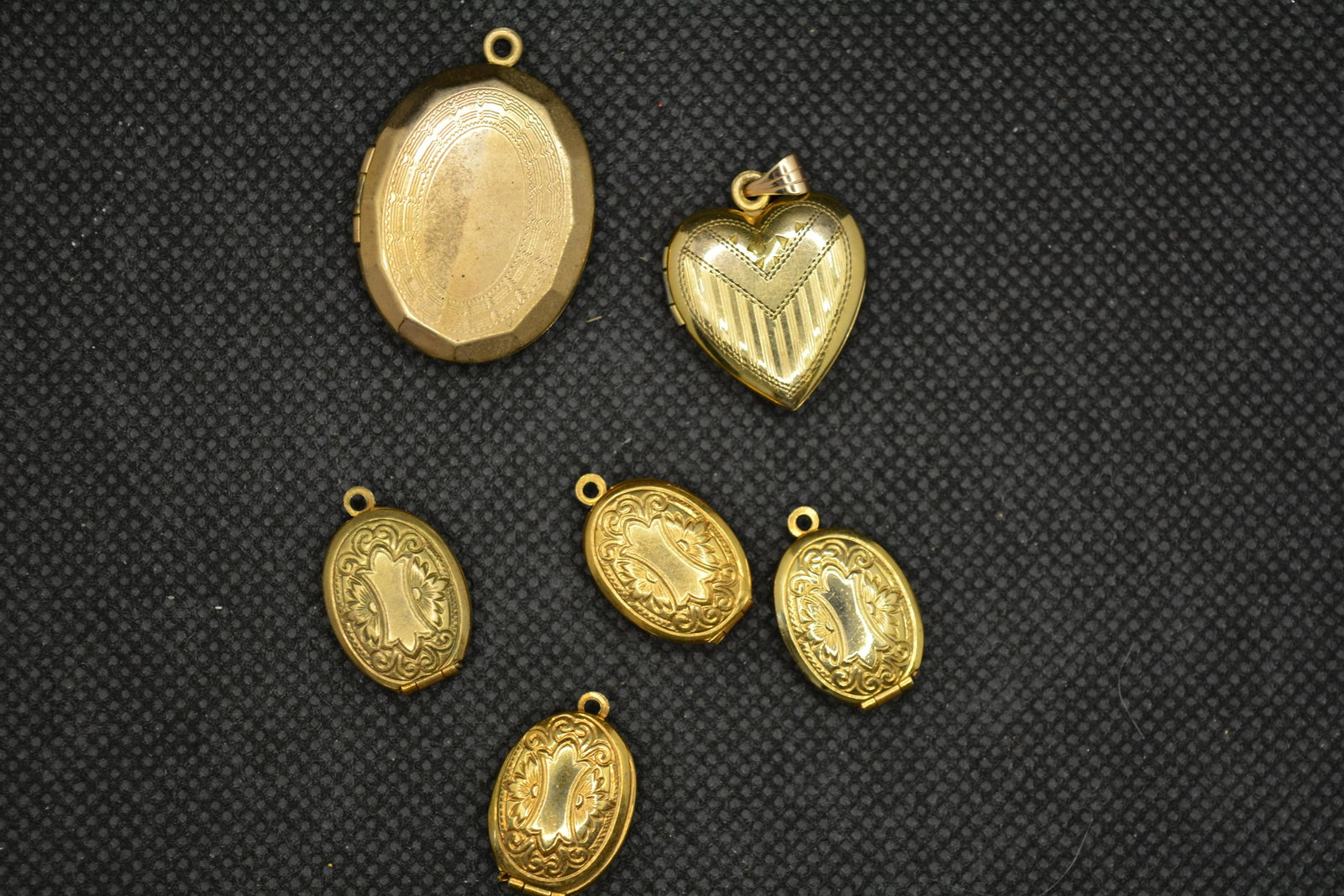 Lot of 6 Vintage Lockets: gold tone lockets, one gold filled heart shaped, one oval and 4 matching smaller ovals, all etched designs
