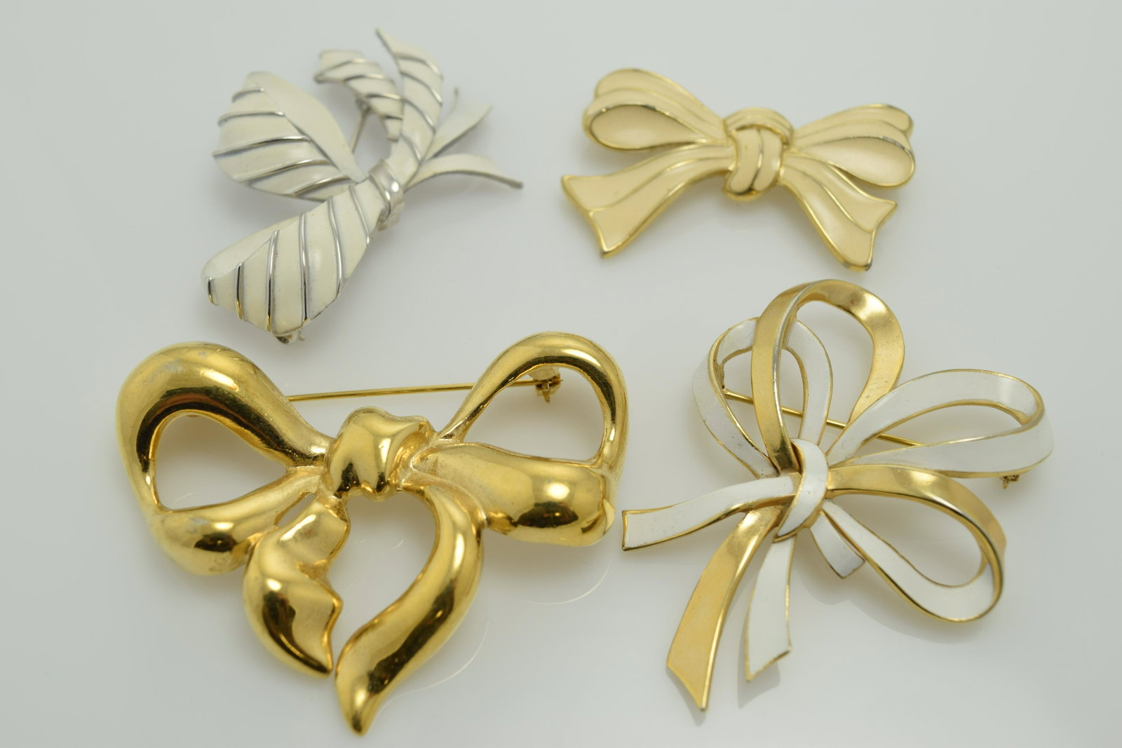 Lot of 4 Vintage Bow Brooches, Trifari & Givenchy: 3 Trifari enamel painted, solid gold tone signed Givenchy