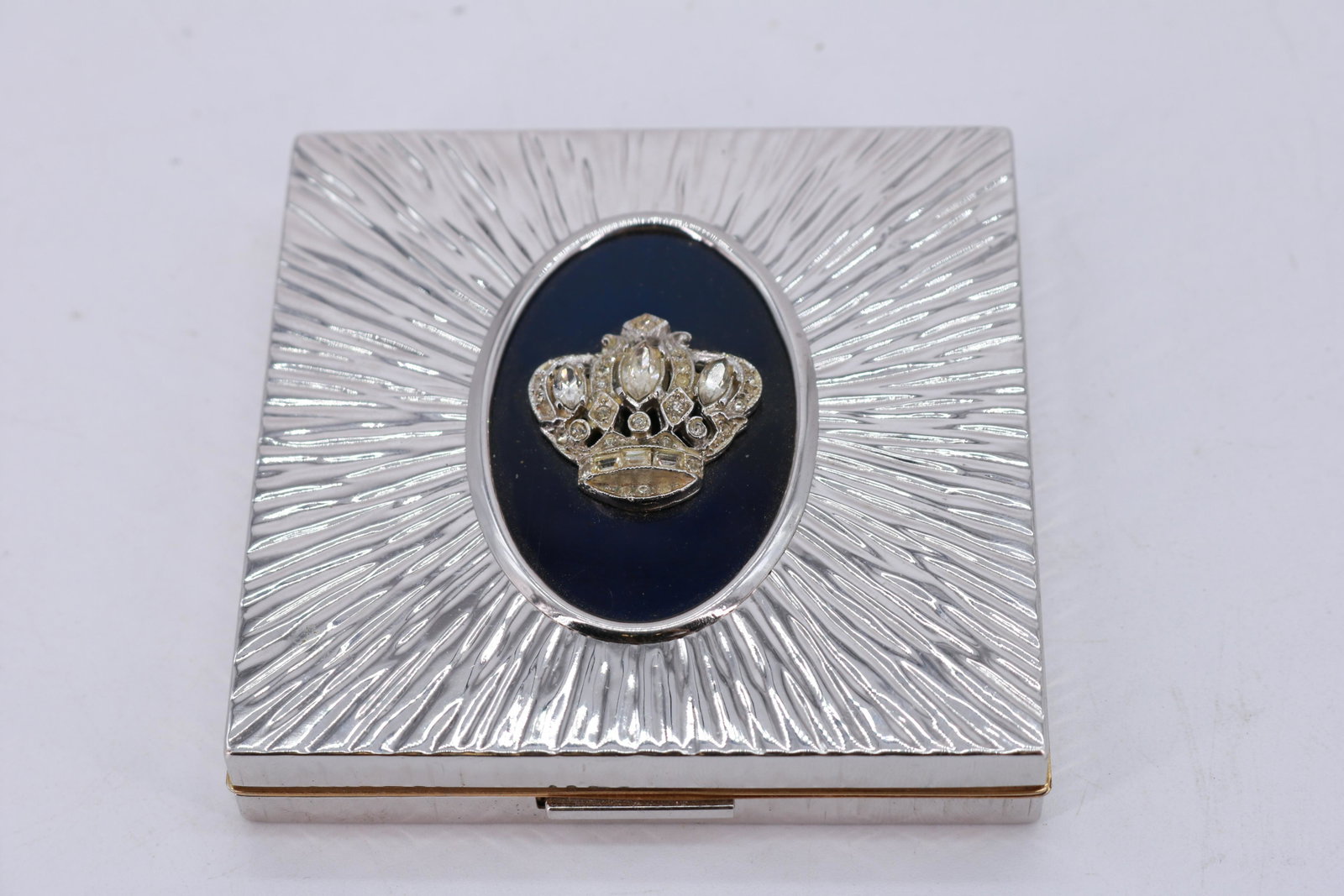 Vintage Evans Powder Compact with Rhinestone Crown: vintage Evans compact in bright silver metal with applied faceted rhinestone crown, has original powder puff and powder inside, approx. 3 1/4 inches
