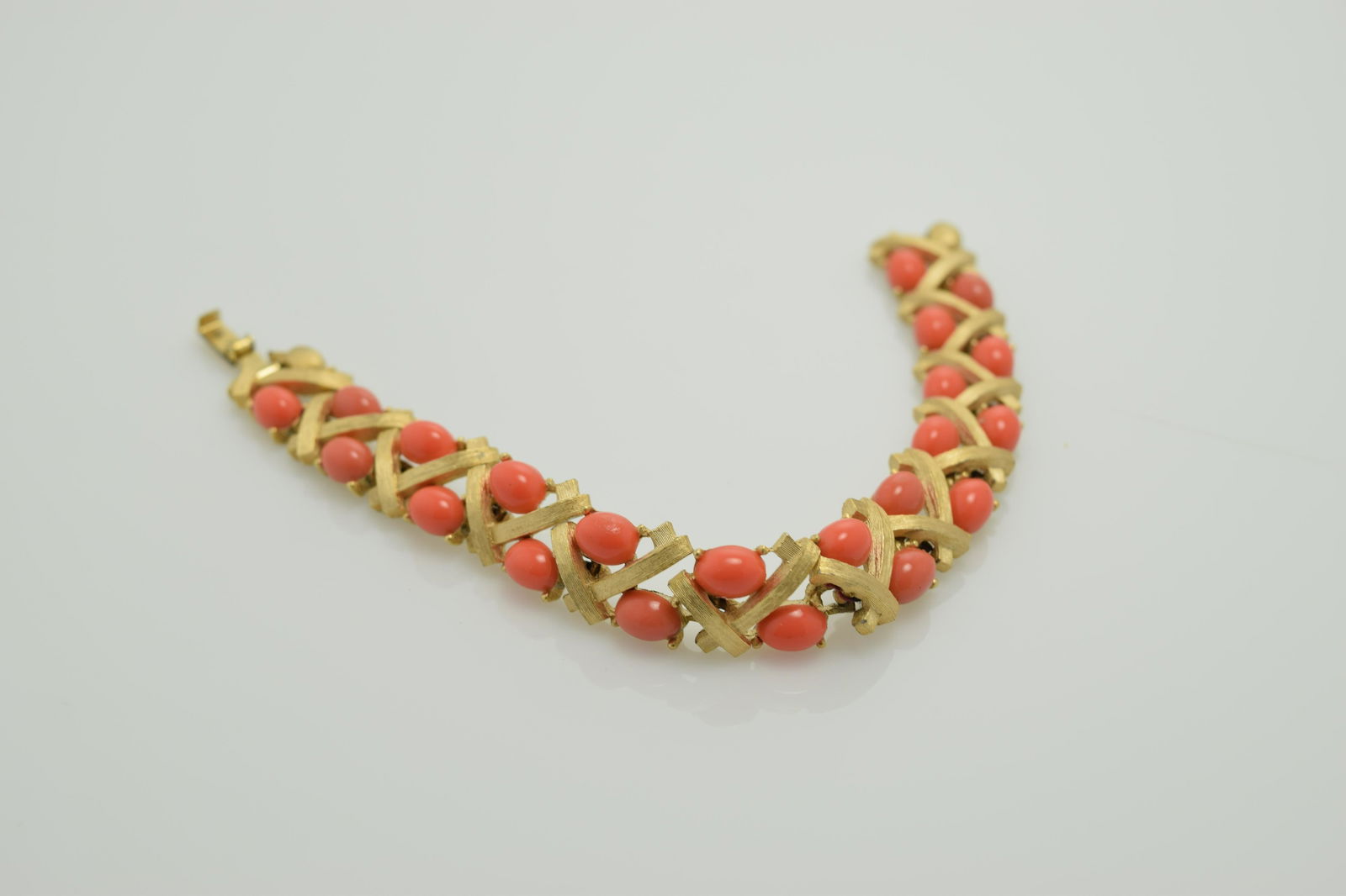 Vintage Trifari Bracelet with Coral Stones: gold tone setting with coaral stones, approx. 7 inches