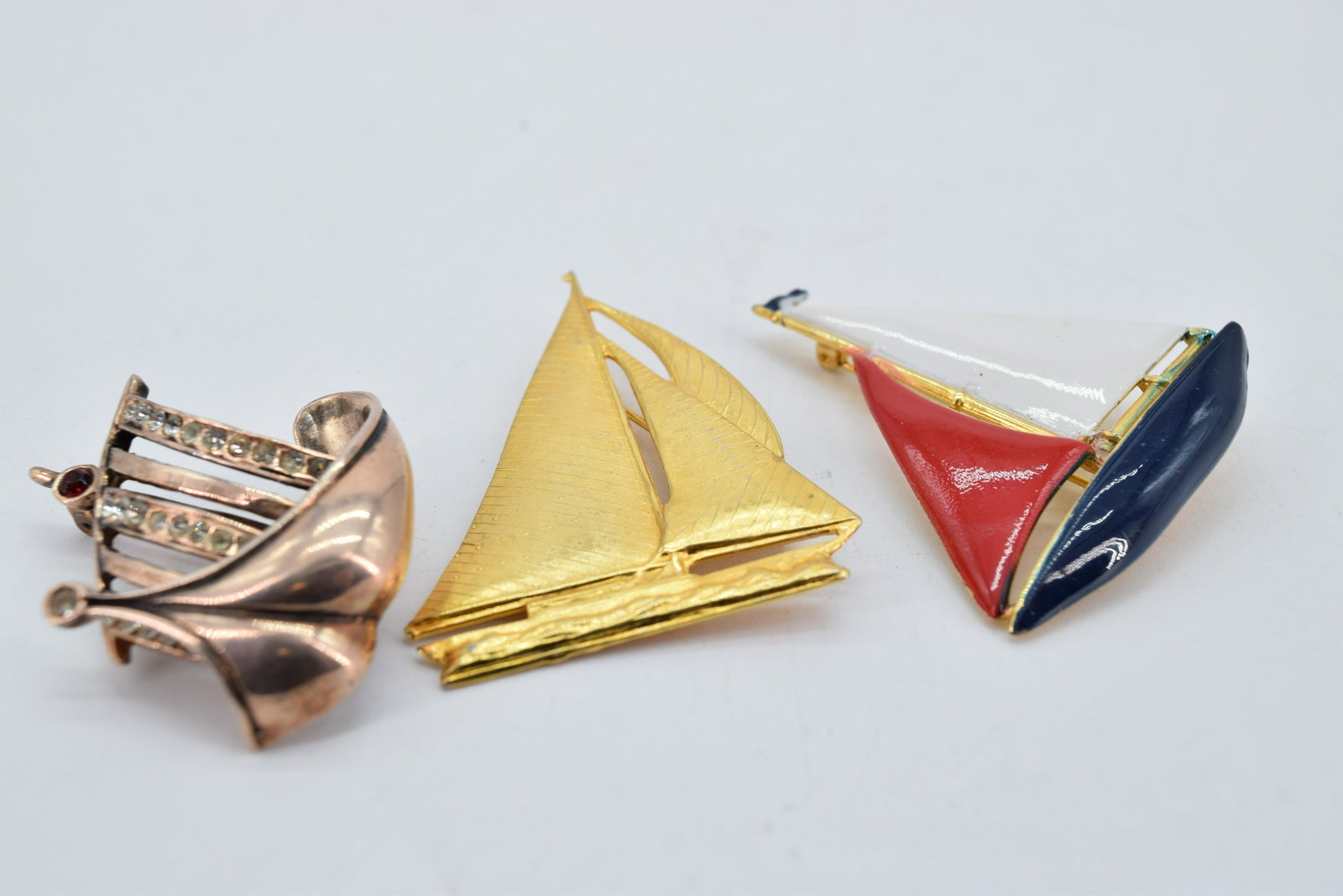 Lot of 3 Vintage Sail Boat Brooches: red white and blue enamel, gold tone sterling with rhinestones, and gold tone