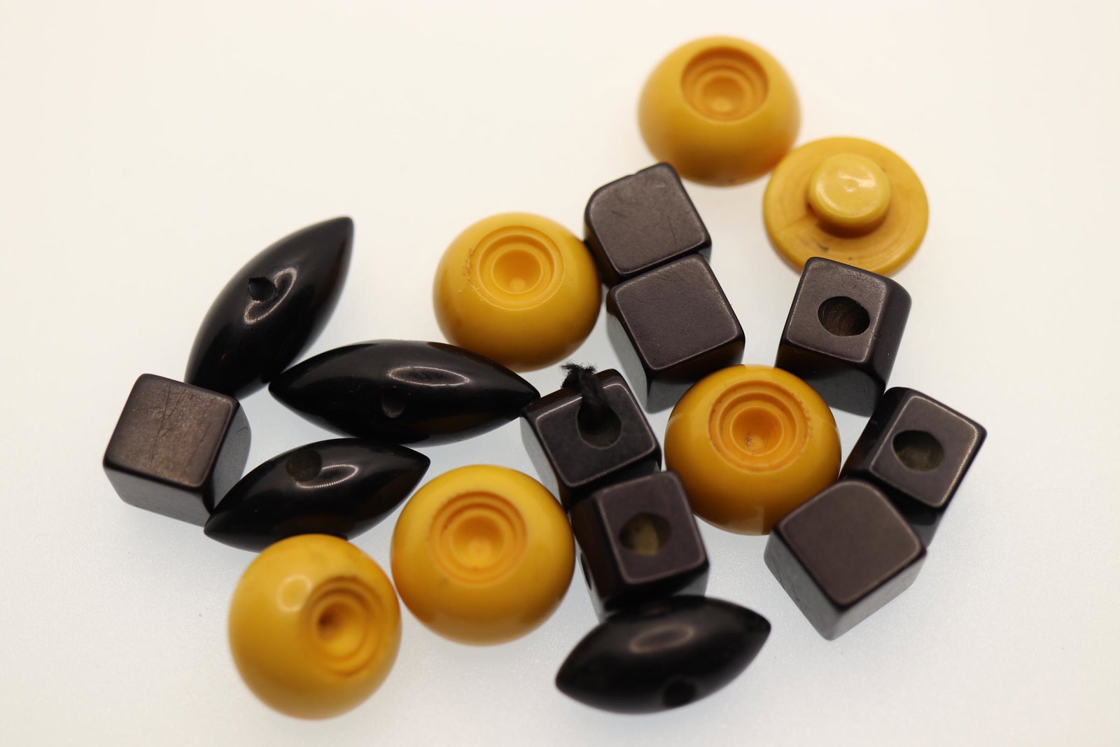 Lot of 18 Bakelite Buttons, 1940's: footballs set of 4 are 1 inch, cubes set of 8 are 1/2 inch, yellow set of 6 are 5/8 inch
