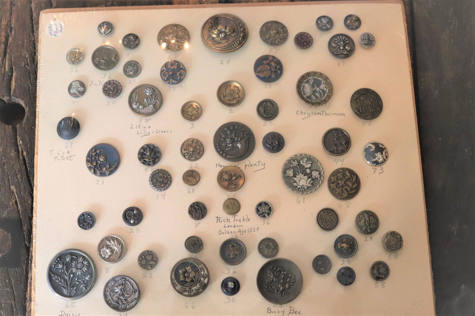 Lot of 48 Antique 1800's Metal Buttons in Sealed Wrap: Stunning lot of buttons to include Chrysanthemum, daisy, busy bee, hope of plenty, lotus lily & leaves, rich treble London golden age 1820, hand with flowers, marcasite and many other picture buttons,