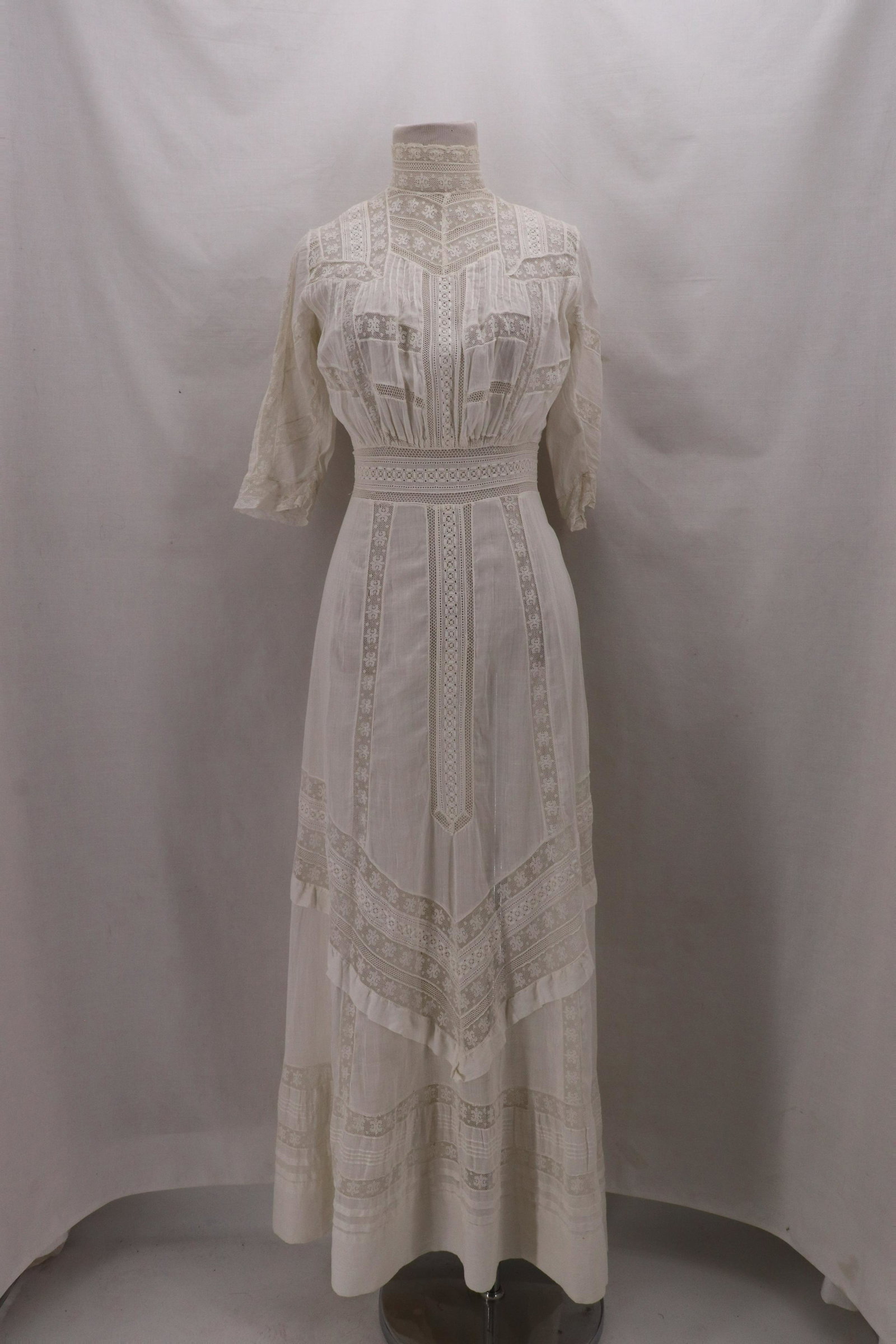 Vintage 1910 White Cotton & Lace Lawn Dress: elbow length sleeve, high collar, inset lace, slightly flared full length skirt with great inset lace detain, mother of peak button back, bust 34, waist 24, some small holes, see photo's