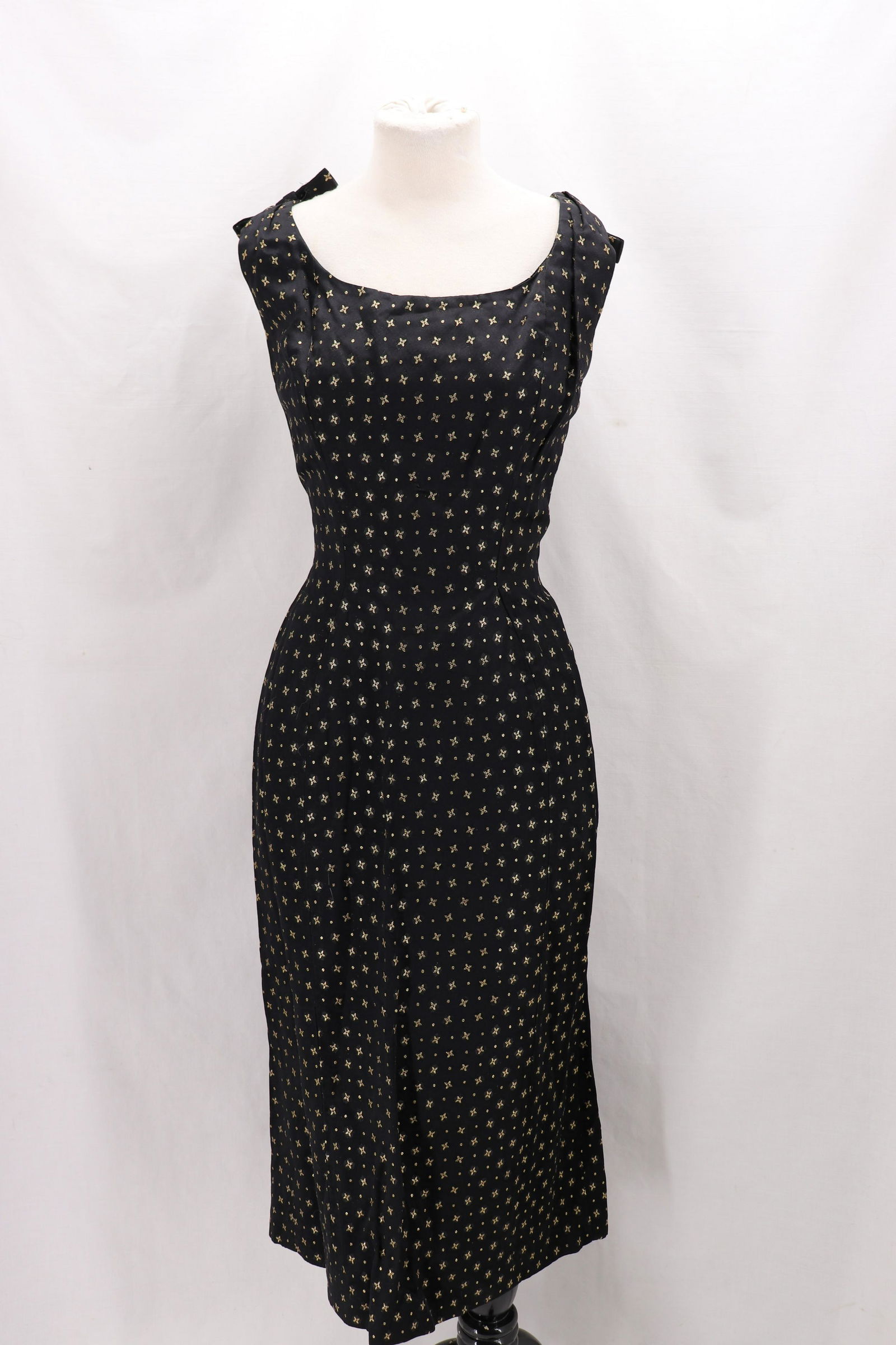 Vintage 1950's Suzy Perette, Satin Brocade Dreaa: sleeveless with bows at shoulders one loose, scoop neck, straight skirt, black with gold metallic thread, bust 36, waist 26, hips 40, large seam repair needed at skirt, back metal zipper