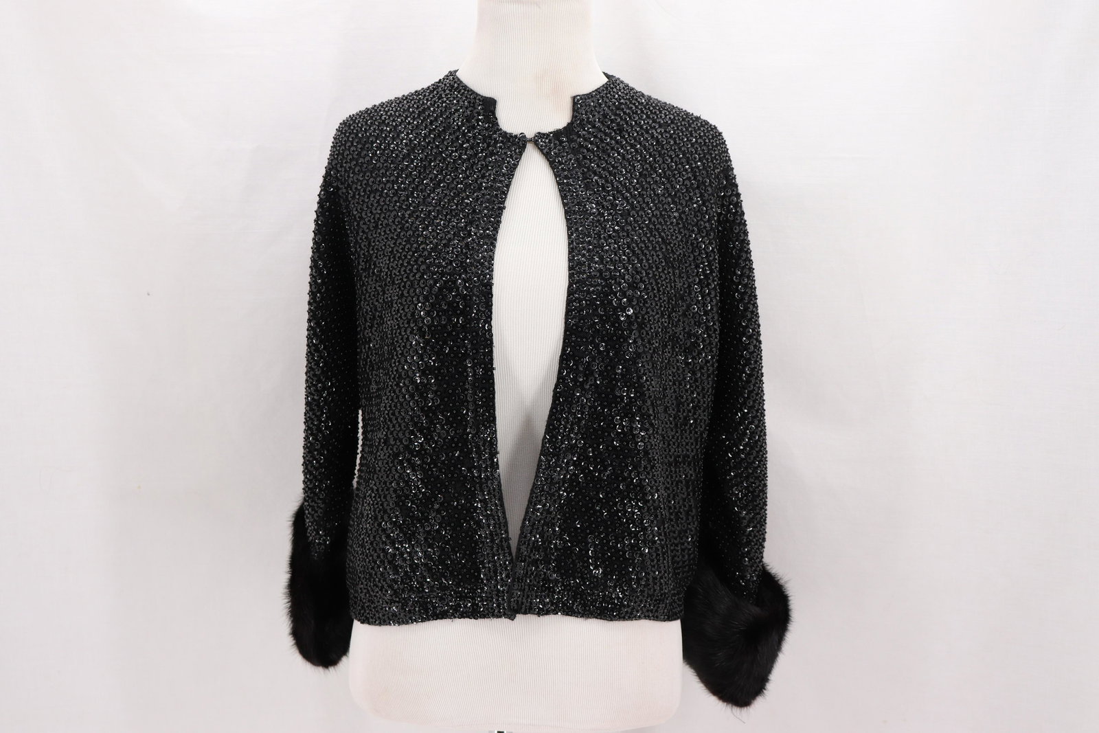 Vintage 1960's Sequin & Mink Cardigan Sweater: 3/4 sleeves with large Mink fur cuffs, eye hooks closure down front, full sequin, bust 34, waist 34, good condition a couple sequin missing at shoulder