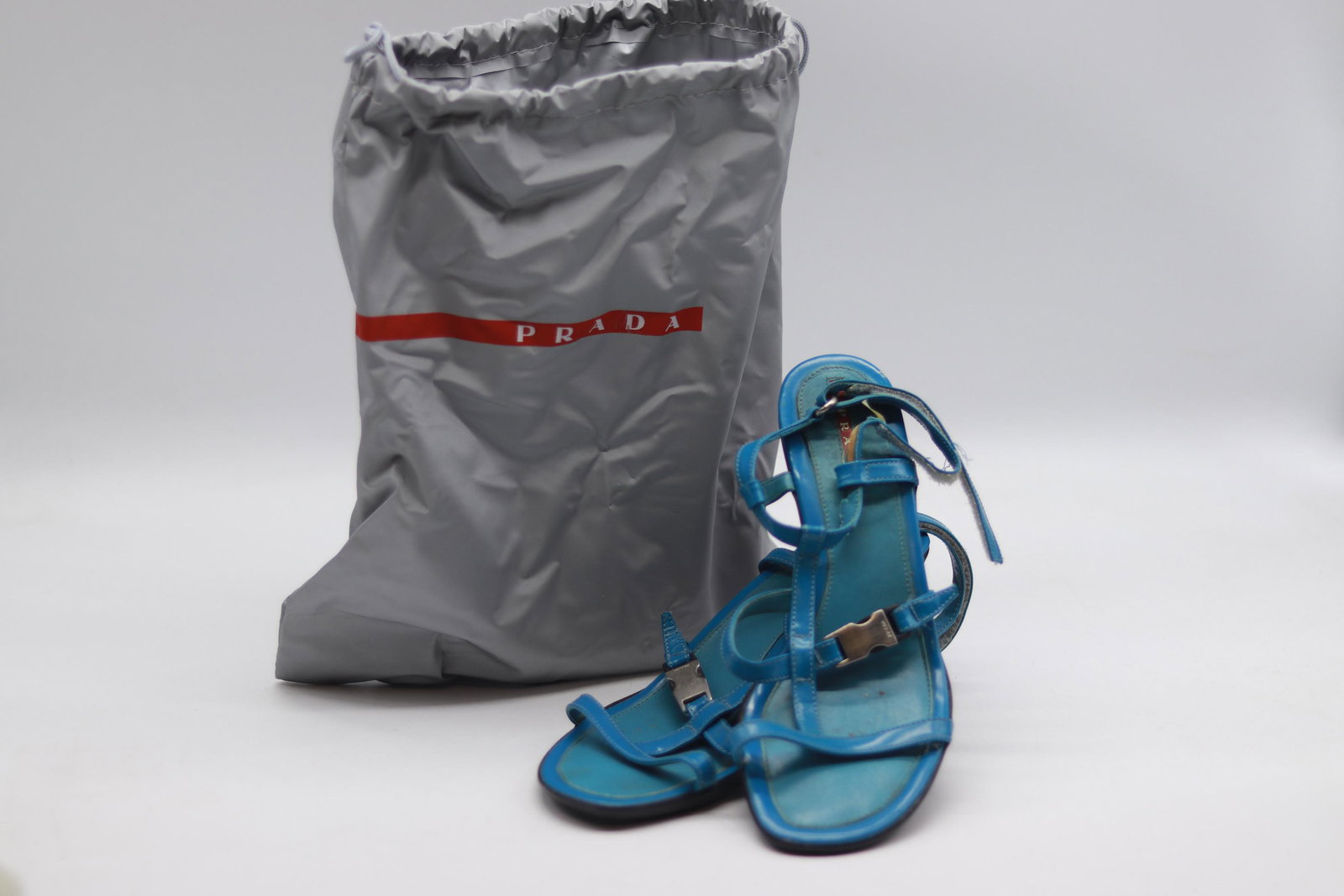 Vintage PRADA Strappy Sandals: blue strappy sandals with kitten style heels, silver tone metal buckle with Prada name, back straps adjustable, slightly worn, size 38