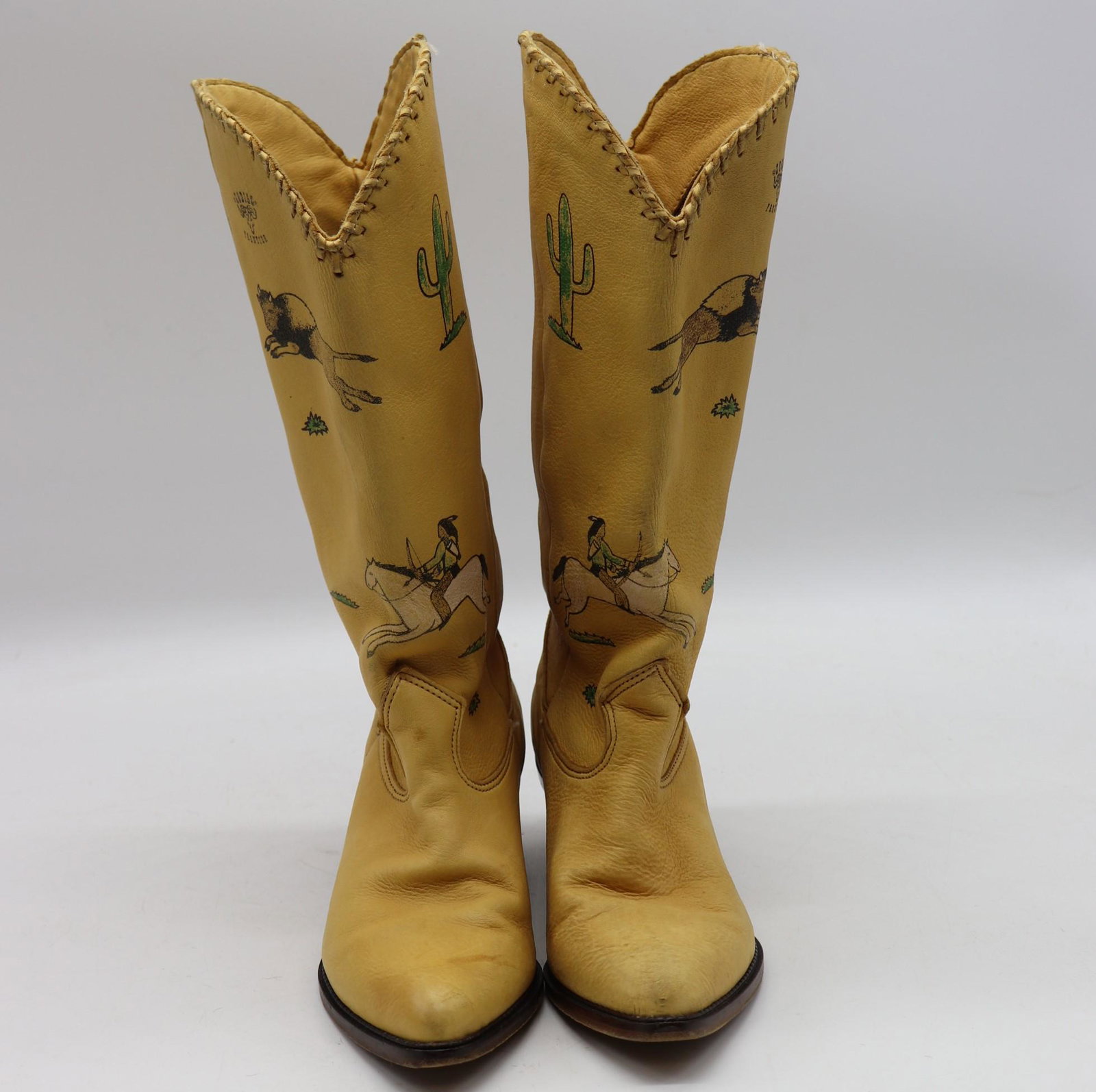 Vintage Zodiac size 6 leather cowboy boots: Used condition yellow mid calf cowboy boots with a frontier themed designs throughout the boots