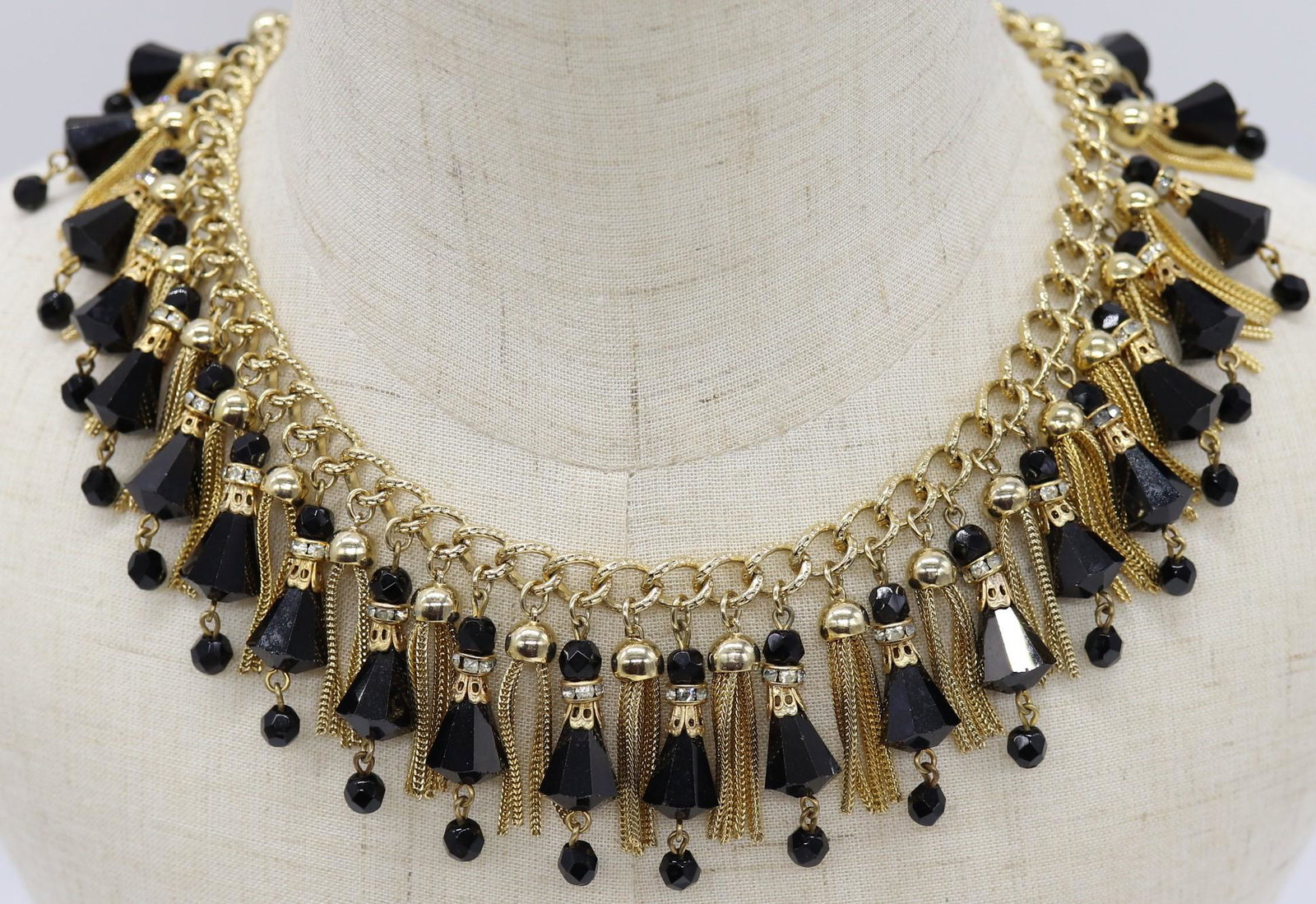 Vintage Vendome Black Jet & Tassel Necklace: signed, gold tone bib style necklace with tassels, and black jet bell shape beads, approx. 17 inches long