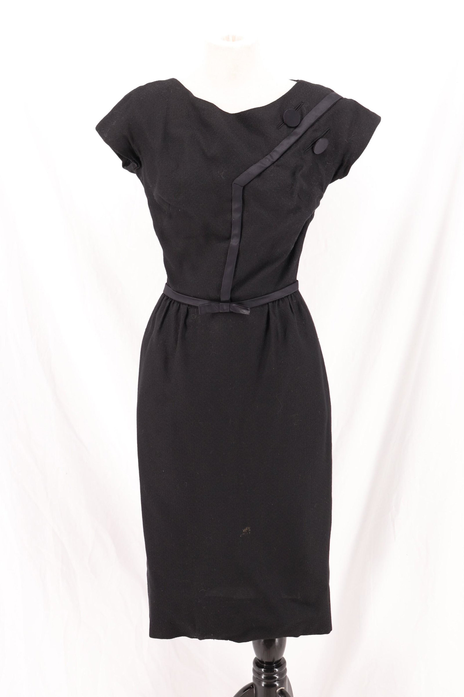 Vintage 1960's HARVEY BERIN by Karen Stark Black Wiggle: wool blend box weave wiggle cocktail dress, cap sleeves, bateau neck, satin trim with 2 satin buttons, satin bow at waist, back metal zipper, approx. 36 bust, 26 waist, 38 hips, stain on skirt but I b