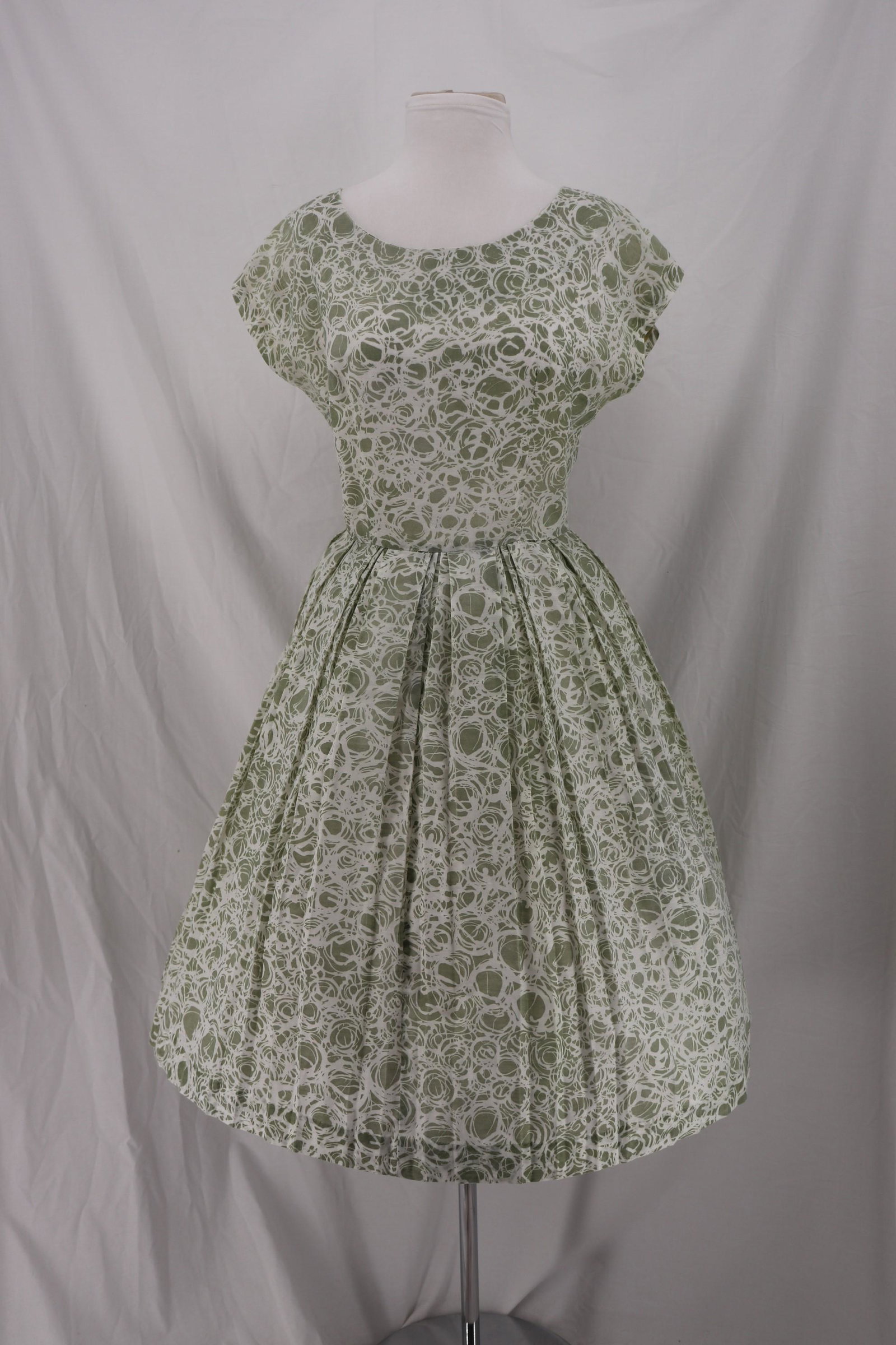 Vintage 1960's Pleated Green & White Dress: cotton blend, cap sleeves, bateau neck, box pleated skirt, back metal zipper, approx. 38 bust, 28 waist, needs seam repair at waist and under arm
