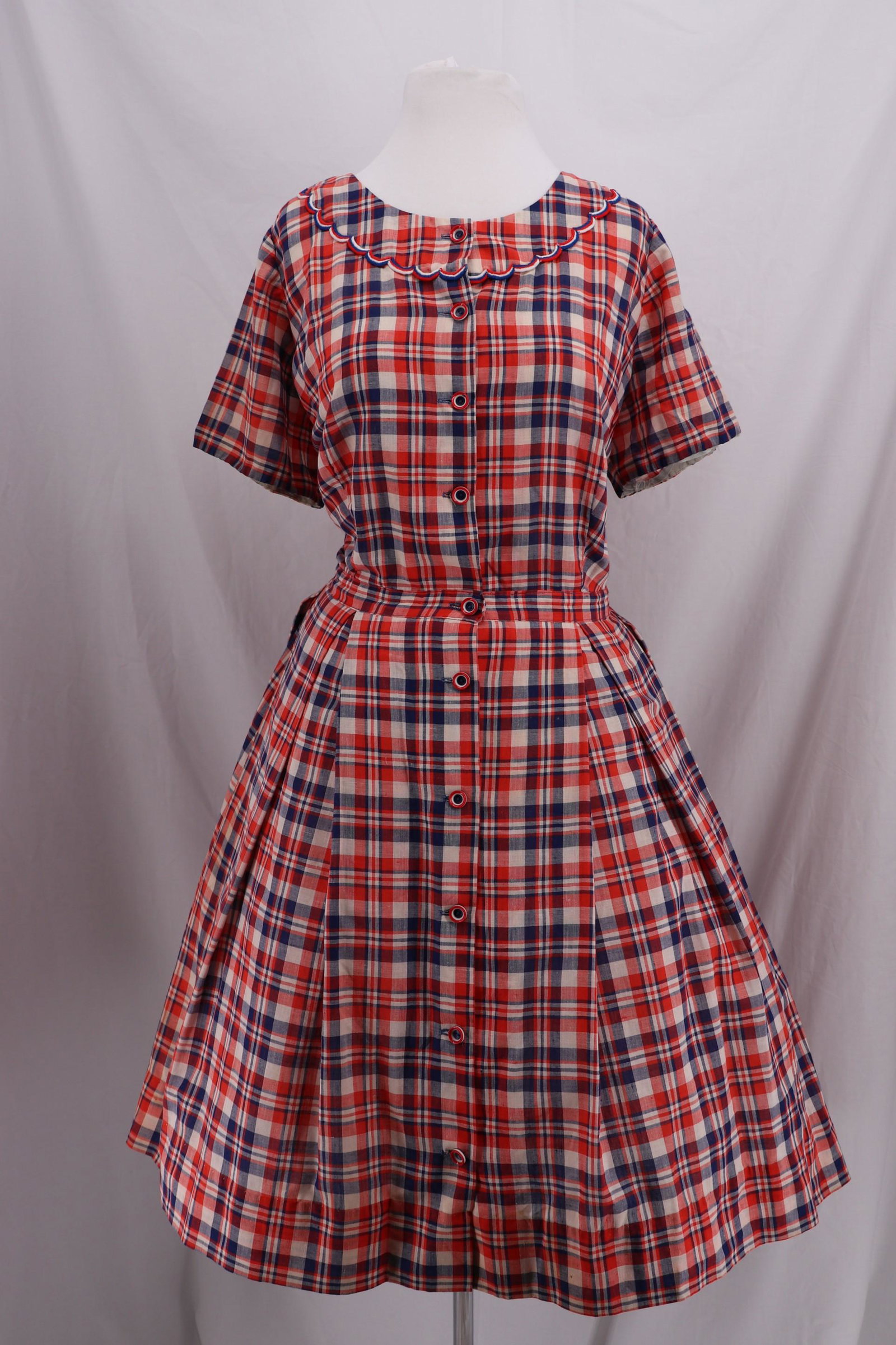 Vintage 1950'd Cotton Day Dress: Short Sleeves, faux collar with red, white, and blue trim, buttons all down front, red white and blue buttons, pleated skirt, Approx. 50 bust, 40 waist, need seam repair on underarms and breast darts.