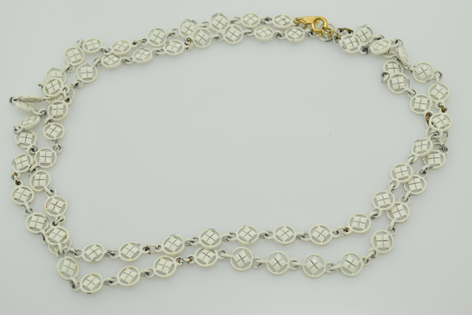A Monet white enamel fancy chain long necklace.: An approx. 38" white enamel fancy chain necklace with a Monet hang tag. In pre-owned condition.
