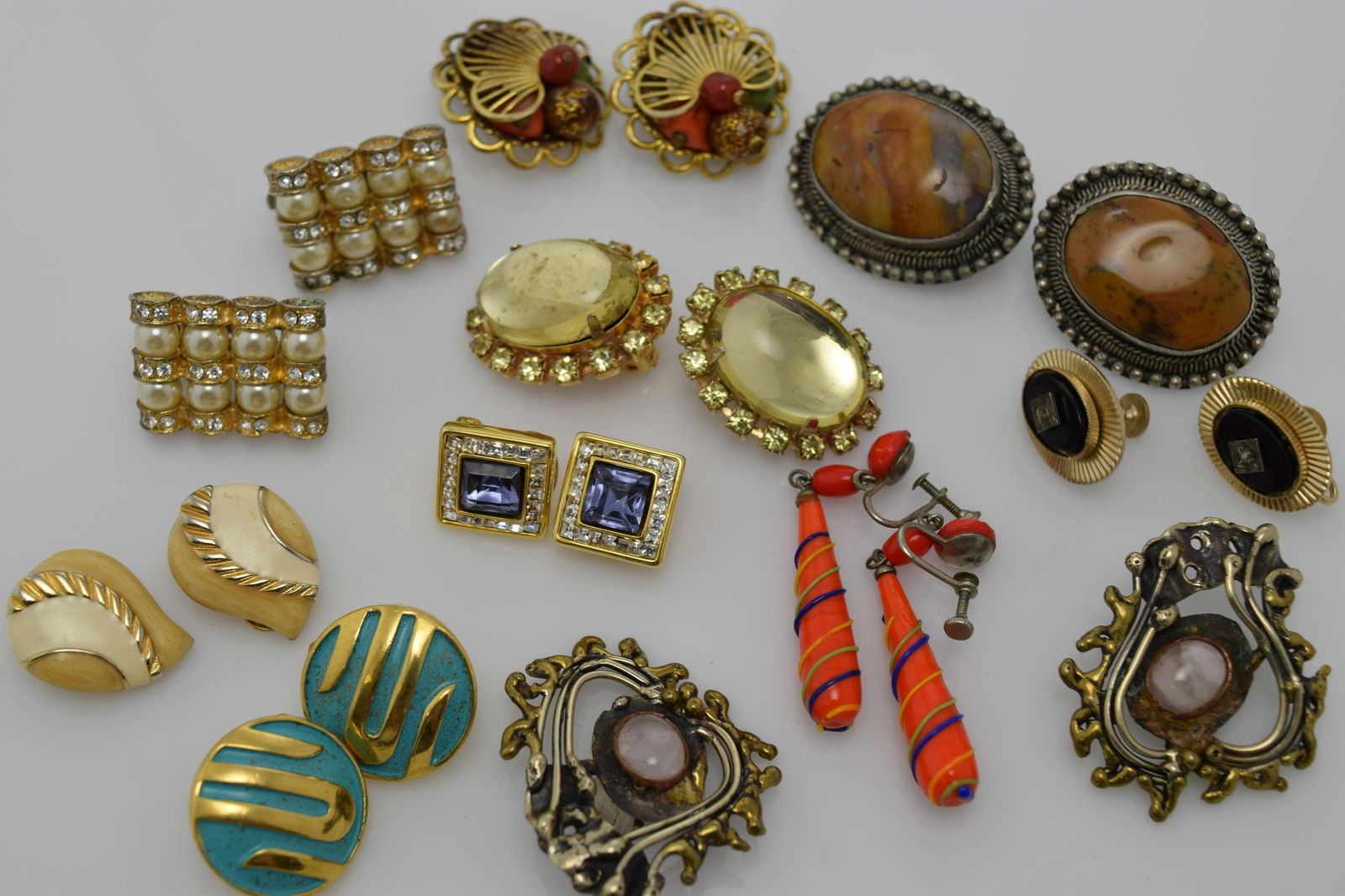 A lot of ten vintage pairs of earrings.: A lot of 10 vintage pairs of earrings. 8 pairs are clip on. 1 pair is signed Trifari & 1 is signed Nolan Miller. None of the other clip on are signed. There are 2 screw backs & is signed Coro. All are