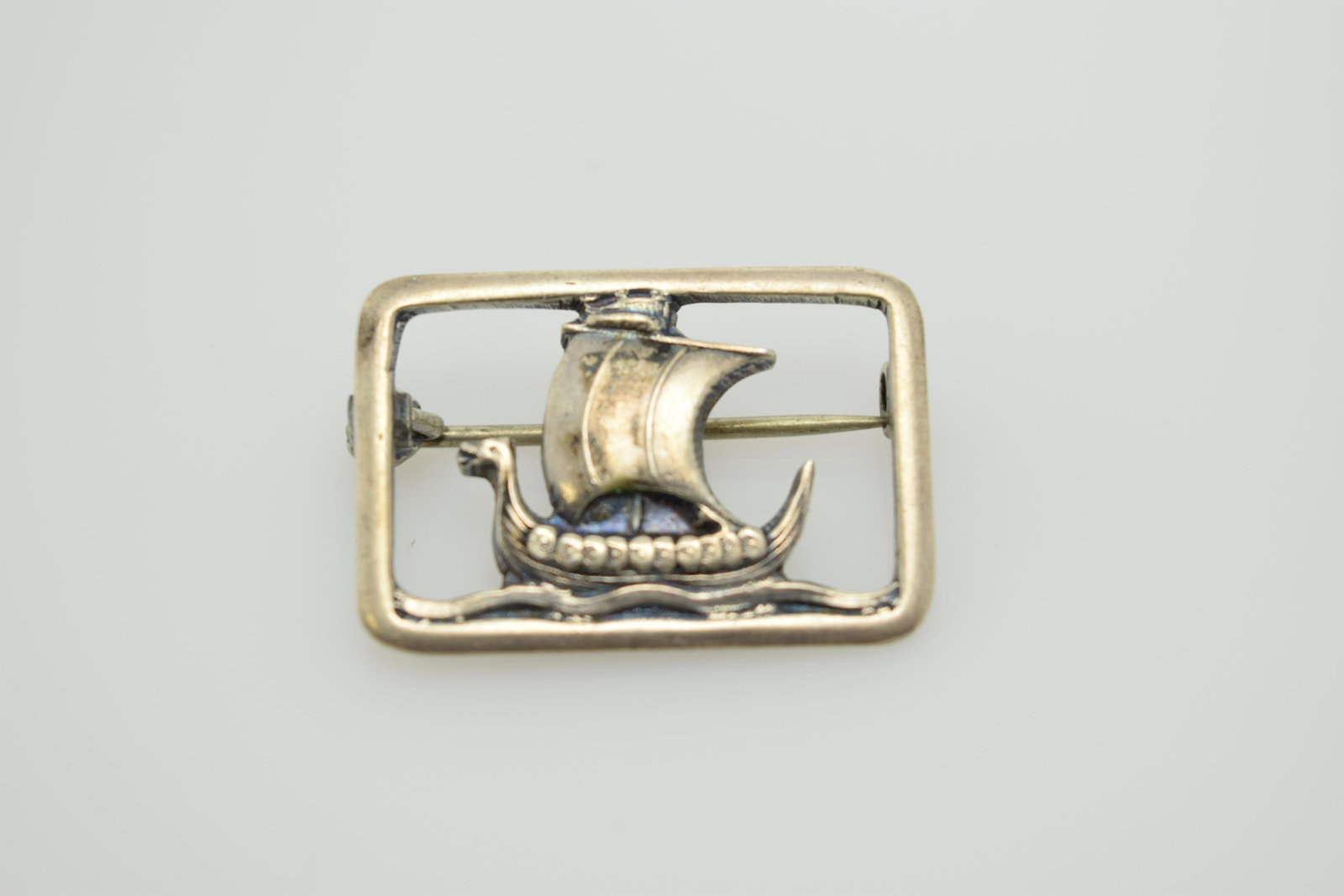 An 830 silver Viking ship made in Denmark pin.: A small (7/8") 830 silver, Viking ship pin with "C" clasp marked COF 830S HAADARBEJDE. In good condition.