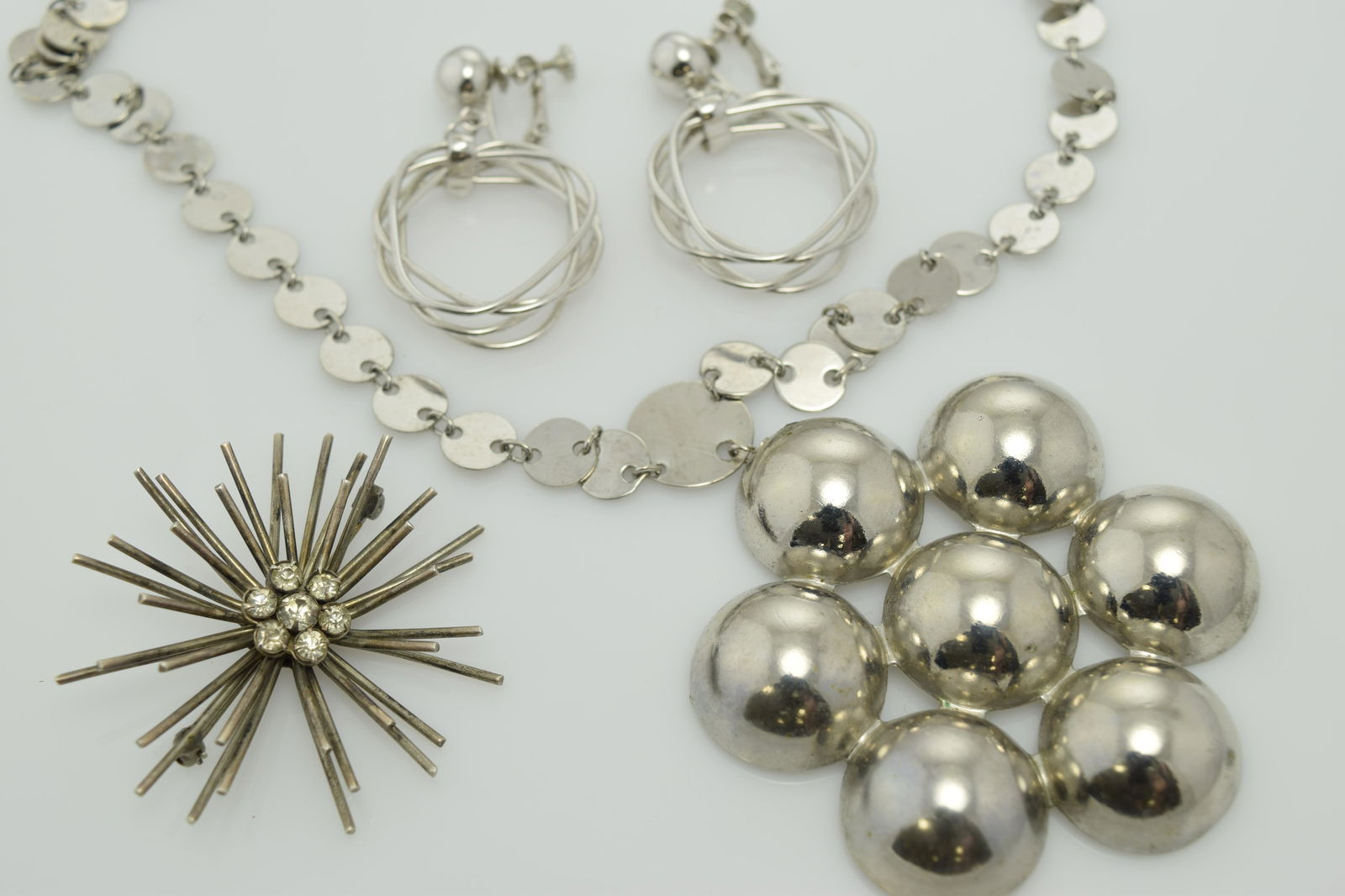 A lot of silver tone necklace, pin, and a pair of (1 of 2)