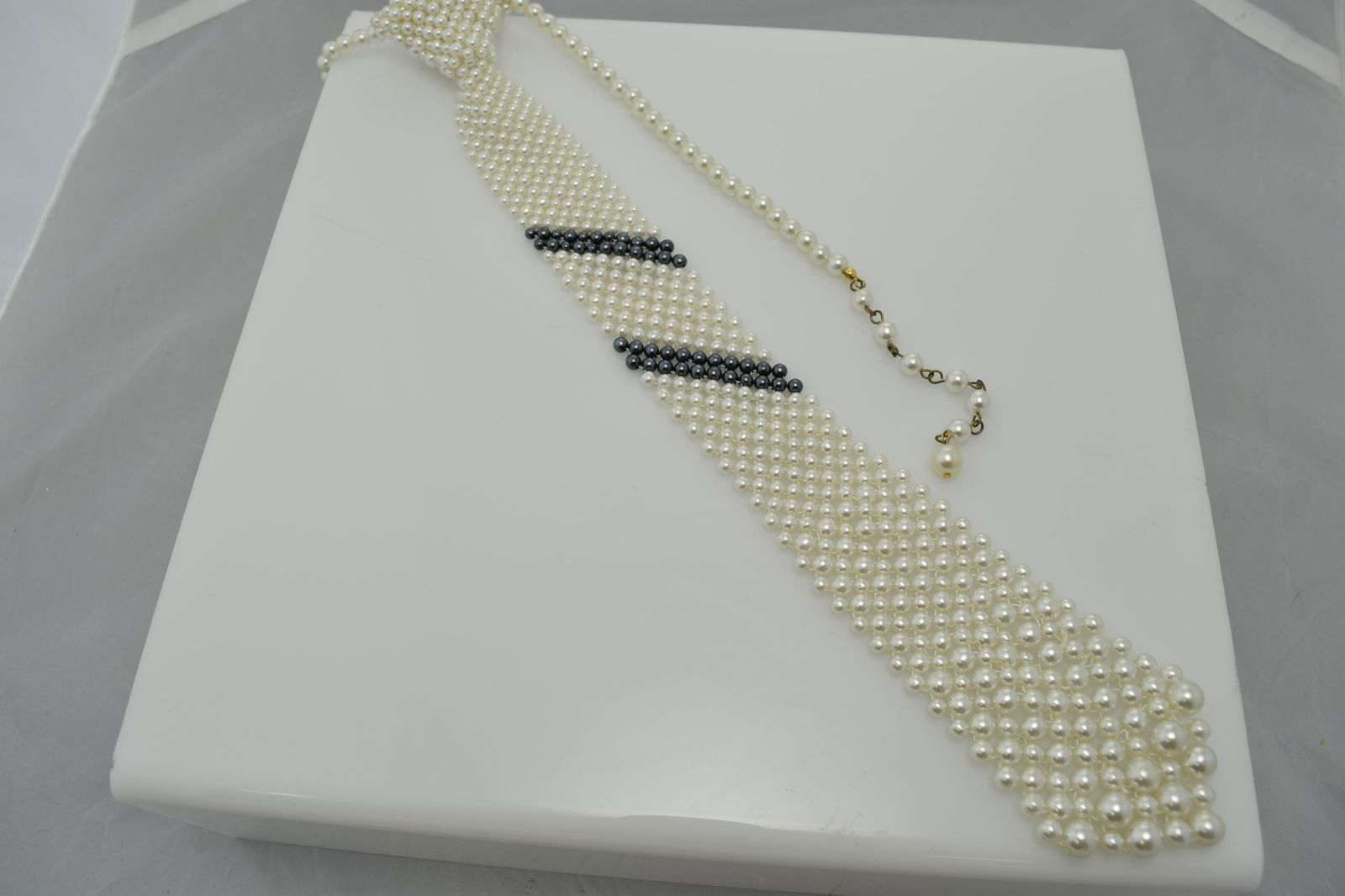 A man's tie necklace made of faux pearls. (1 of 2)