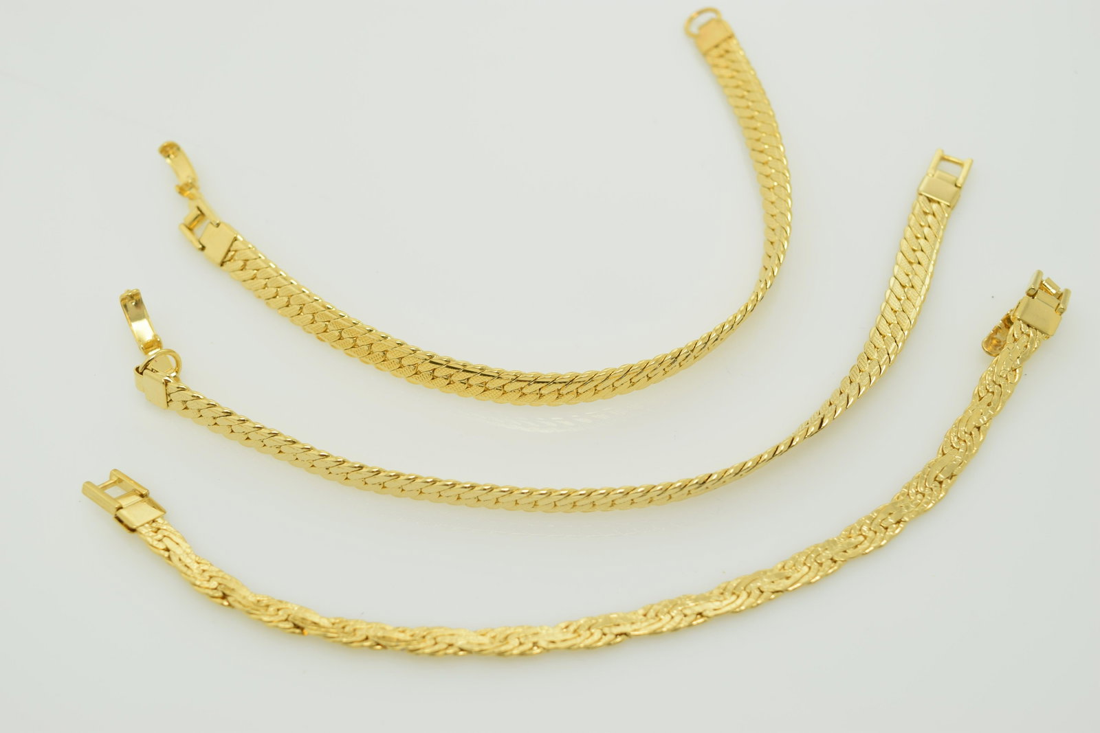 A lot of three signed Monet gold tone bracelets.: A lot of 3 signed Monet gold tone bracelets. All are approx. 7-1/2". 2 match. All are in good condition.
