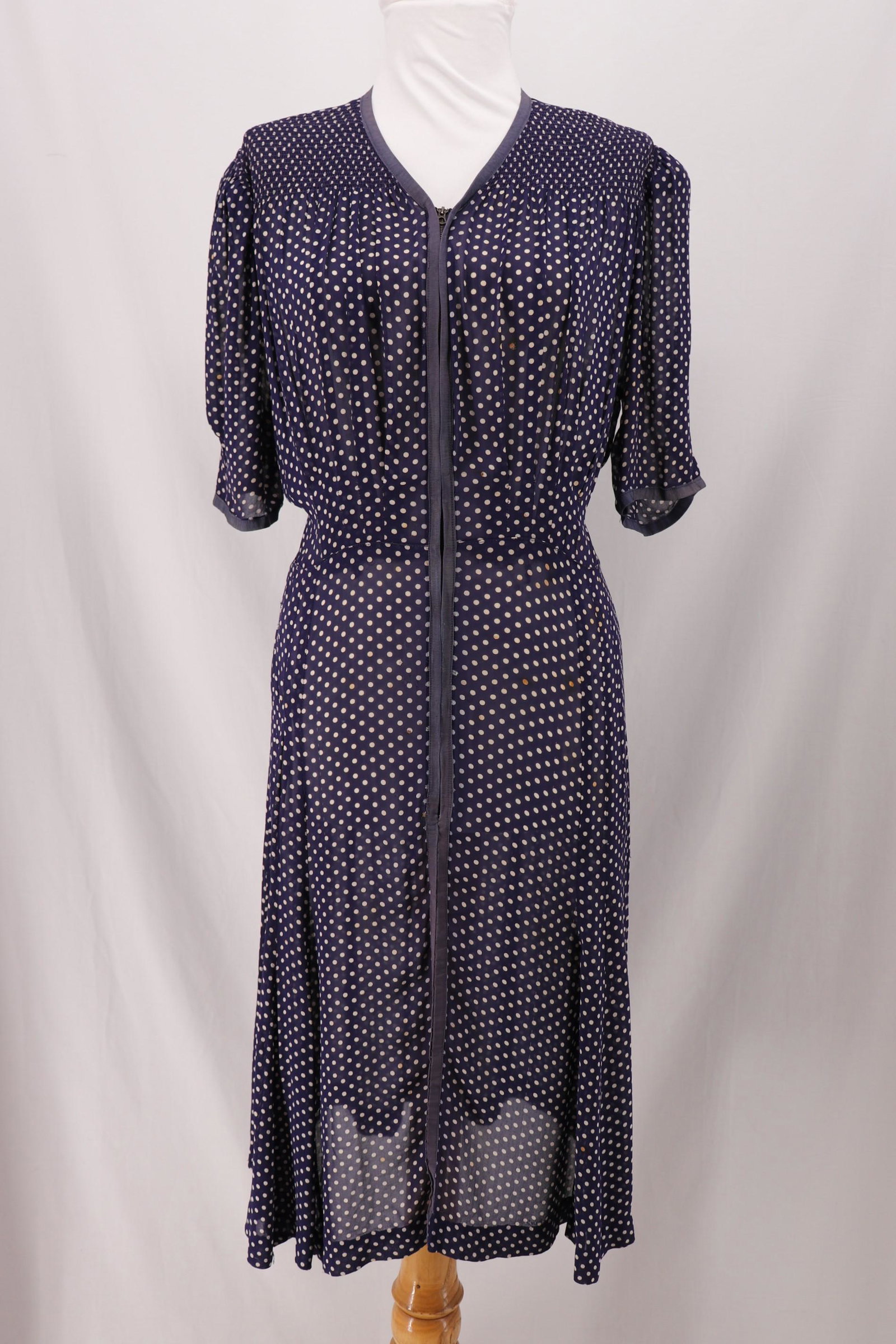 Vintage 1940's Blue Polka-Dot Day Dress: short pouf sleeves with shoulder pads and smocking at shoulders, V-neck with metal zipper front, trimmed in blue ribbon, approx. 44 bust, 34 waist, some stains and holes, see photo's