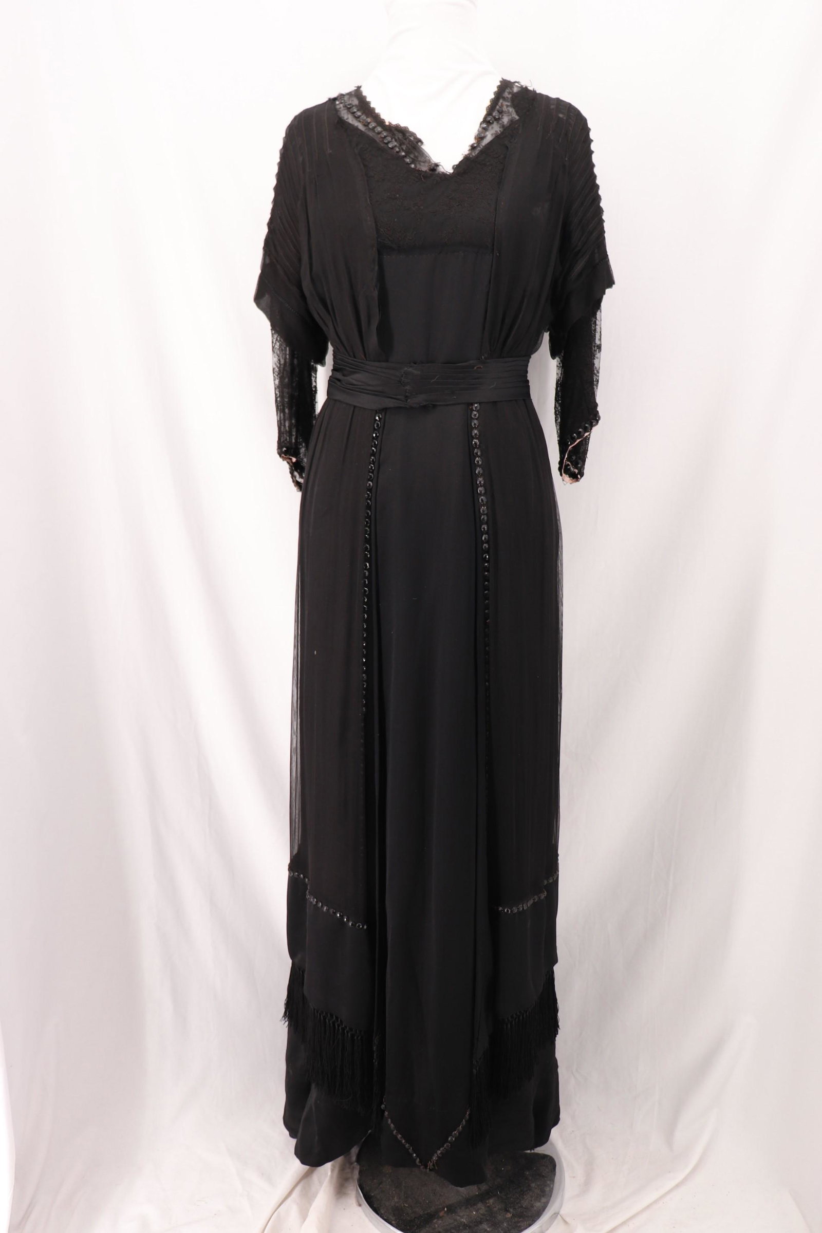 Edwardian Black Gown with Lace, Beading and Tassel: cap sleeves with lace under trimmed with beads, lace insert collar, with beads, pleated sash at waist, full length skirt with bead trim and tassel fringe, fabrics, from satin, lace and sheer nylon ?. 