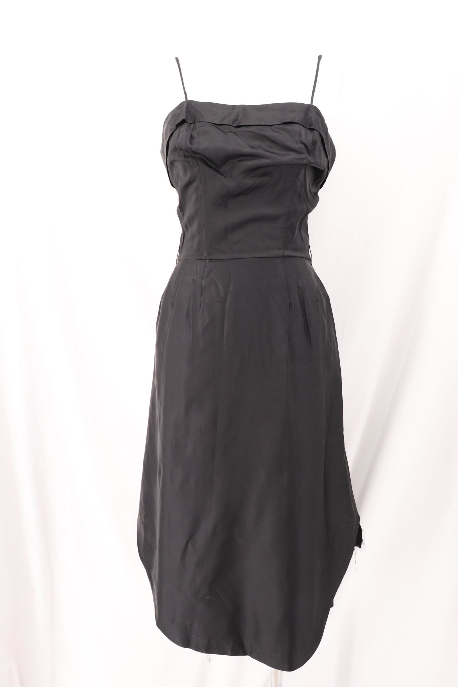 Vintage 1950's Black Cocktail Dress with Bustle: Spaghetti straps, straight front with fold, boned bodice, darts at waist, layered gathered ruffled bustle, back metal zipper, approx. 36 bust, 26 waist, some deodorant marks, one small white dust spot