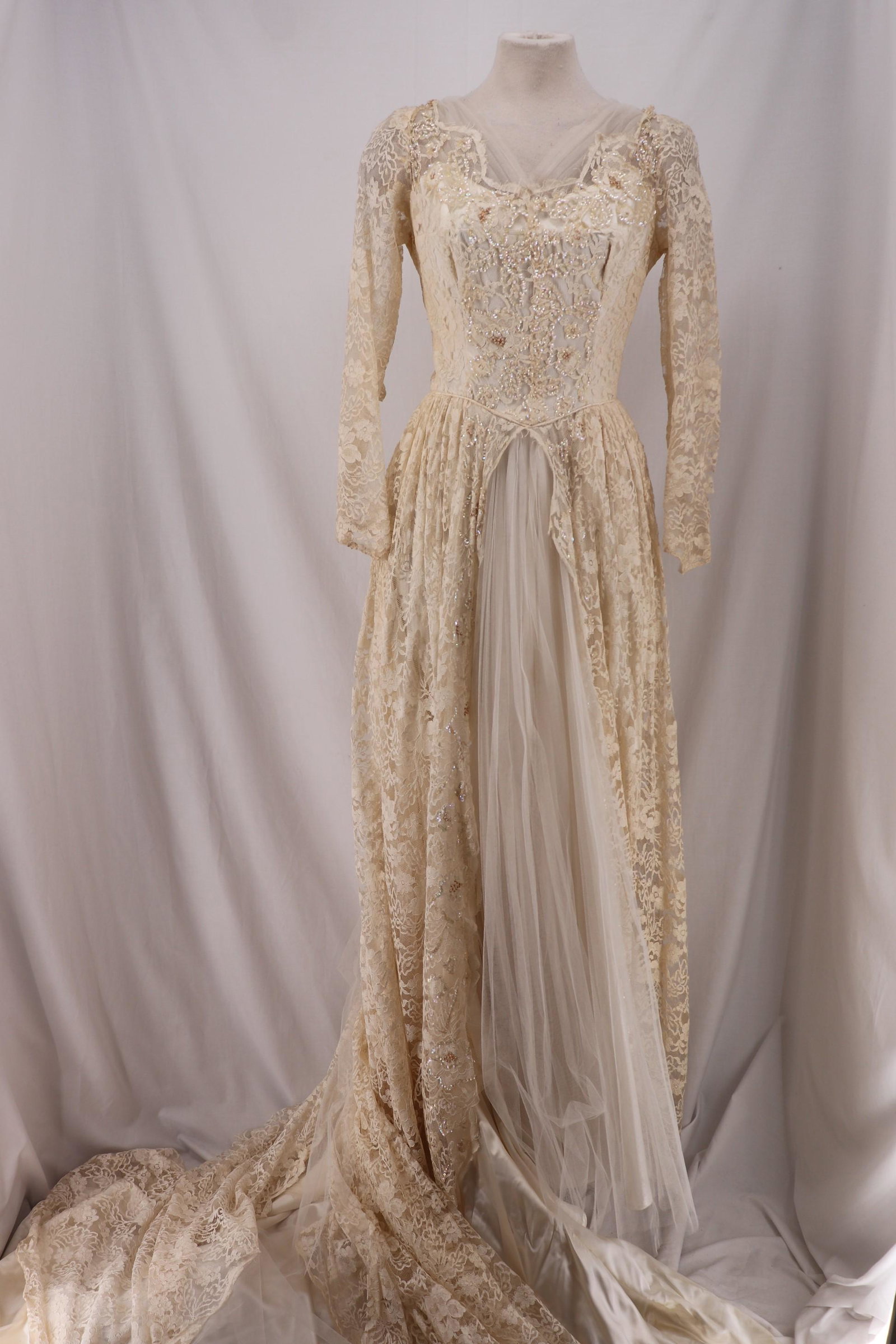 Vintage 1950's Lace and Sequined Wedding Dress: Long sheer lace sleeve's fabric button cuff's, sweetheart bodice with lace and sequin, insert pleated tulle at neck, full length lace skirt and train…accordion pleated tulle in front, satin unde