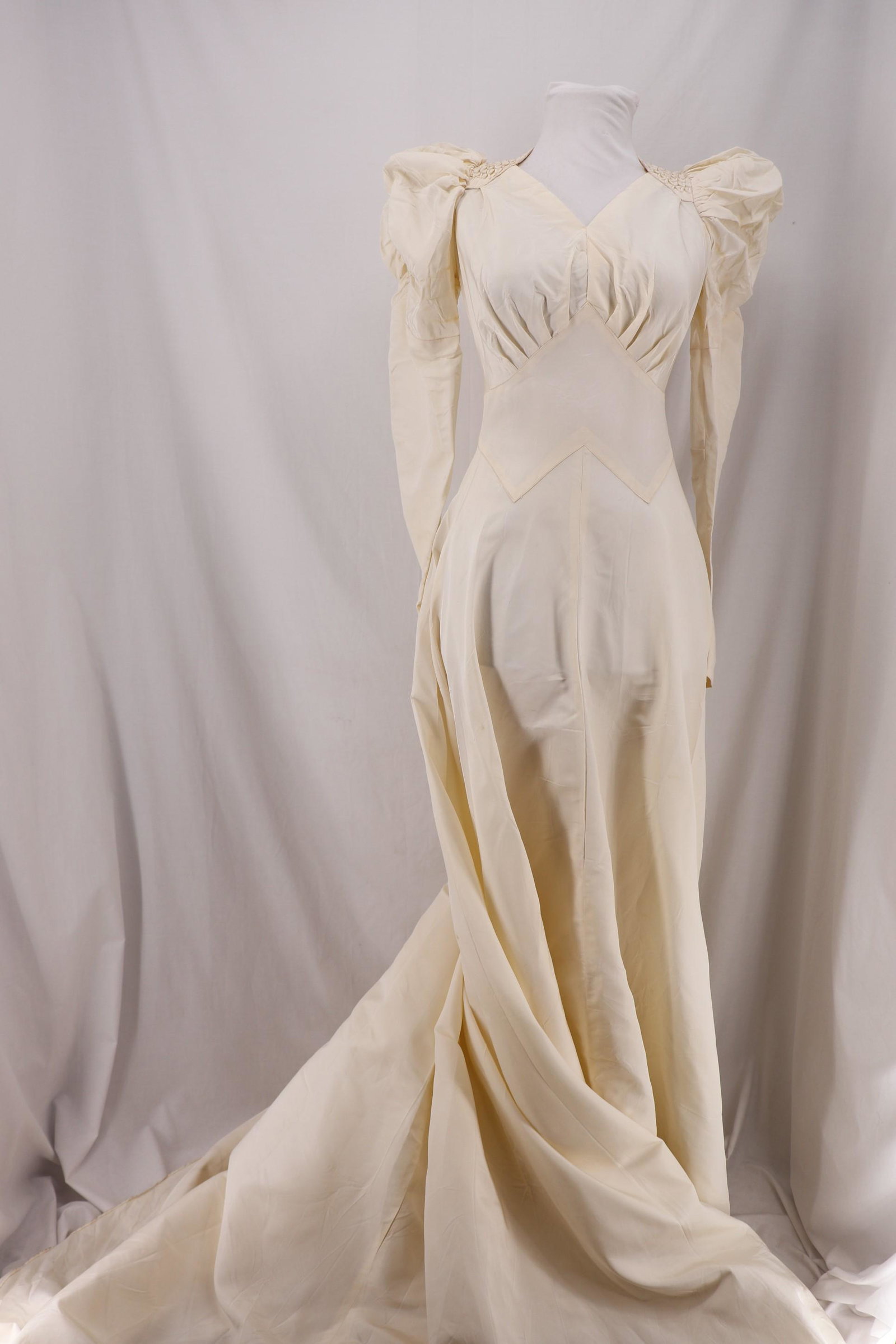 Vintage 1930's Taffeta Wedding Dress: long finger tip sleeves, pouf shoulders, with smocked detail, V-neck, waist comes to point between breast, flowing skirt with train, loop and fabric buttons up back, approx. 34 bust, 24 waist, some un