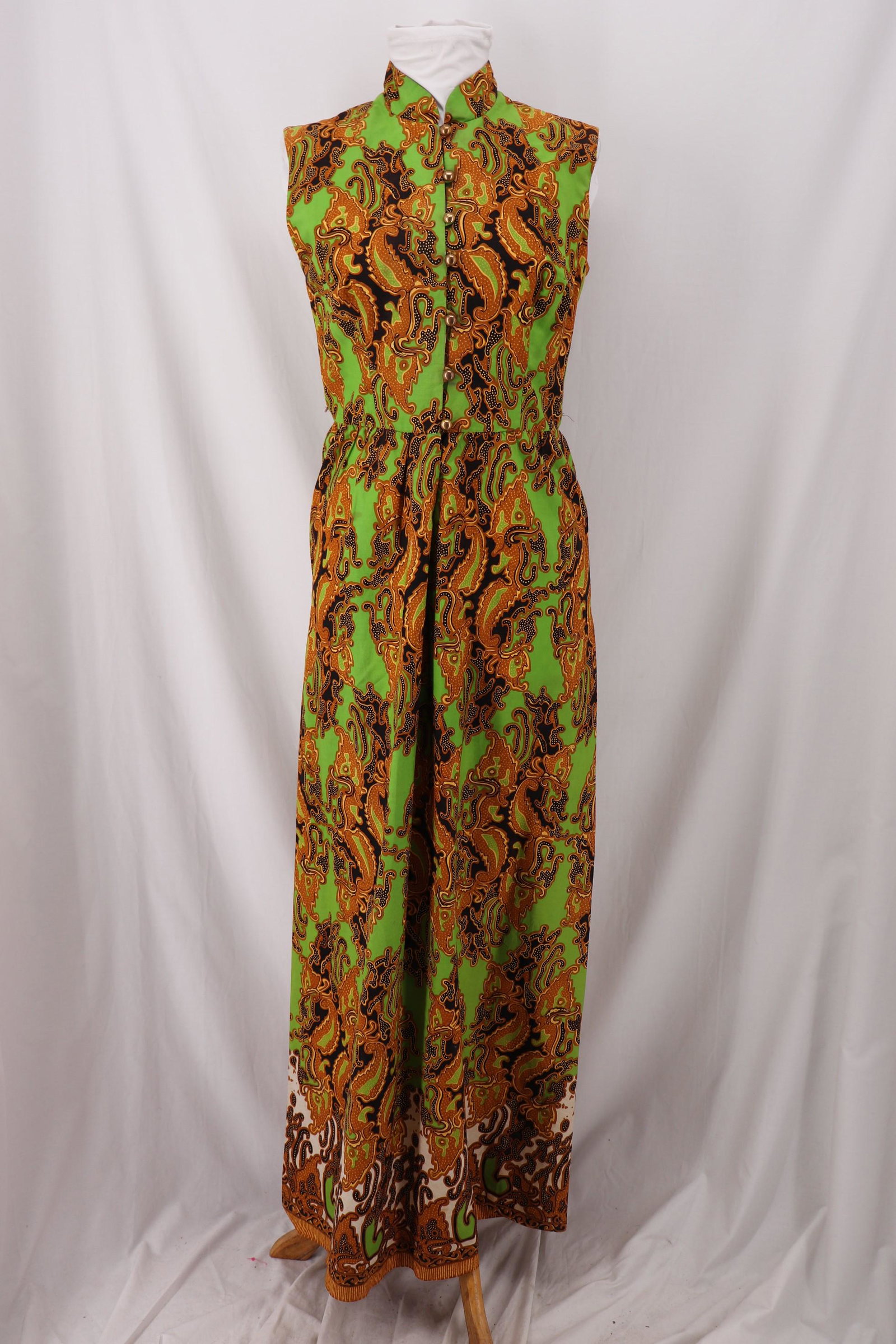 Vintage 1960's Miss Milli Hawaiian Maxi Dress: sleeveless, mandarin collar, loop and button front, sits at waist, slightly gathered, maxi skirt, cotton paisley print, Approx. 34" Bust 26" Waist small tear at one underarm, other needs seam repair. 
