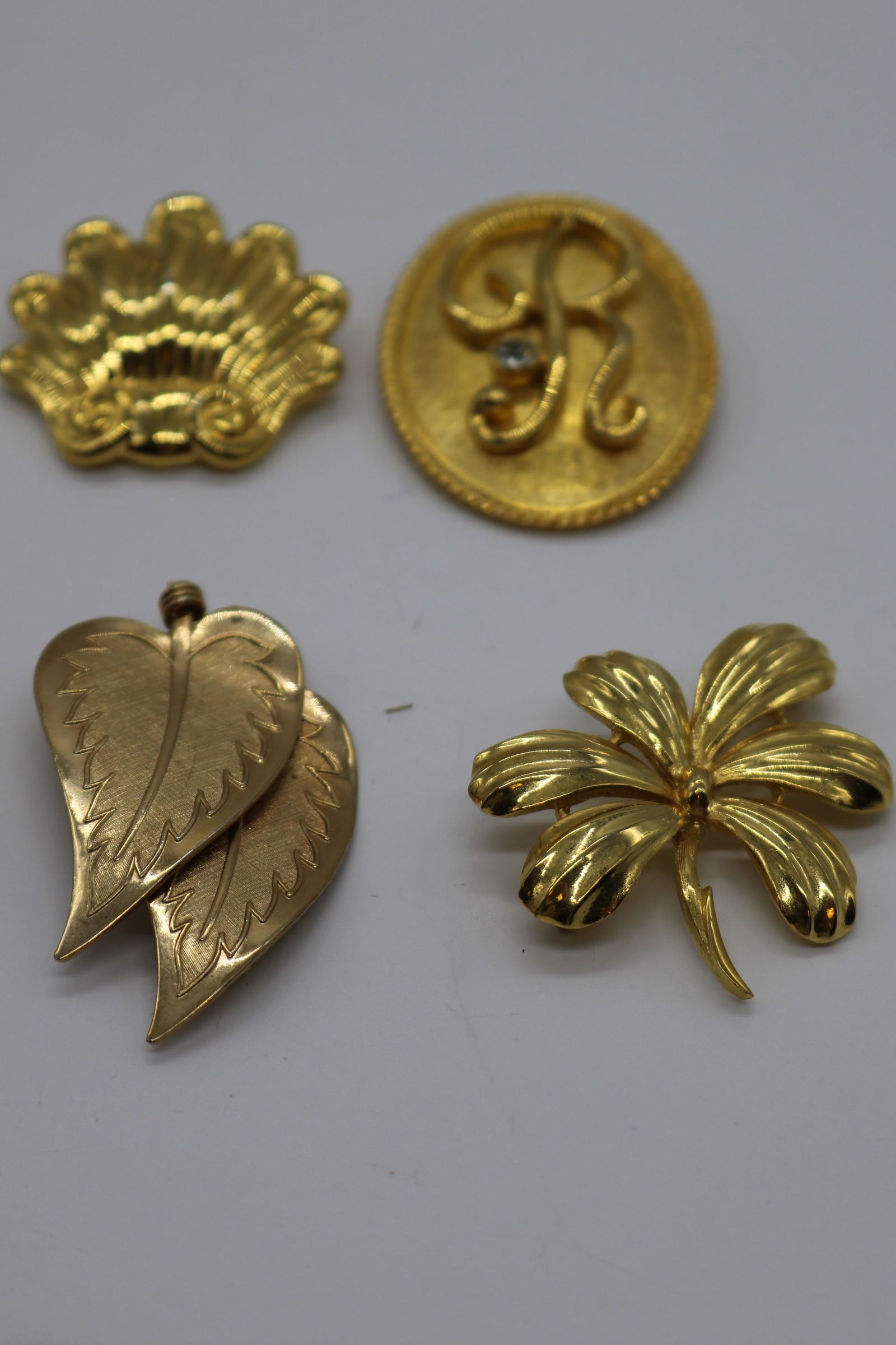 A lot of four gold tone pins/brooches.  Signed Craft, (1 of 7)
