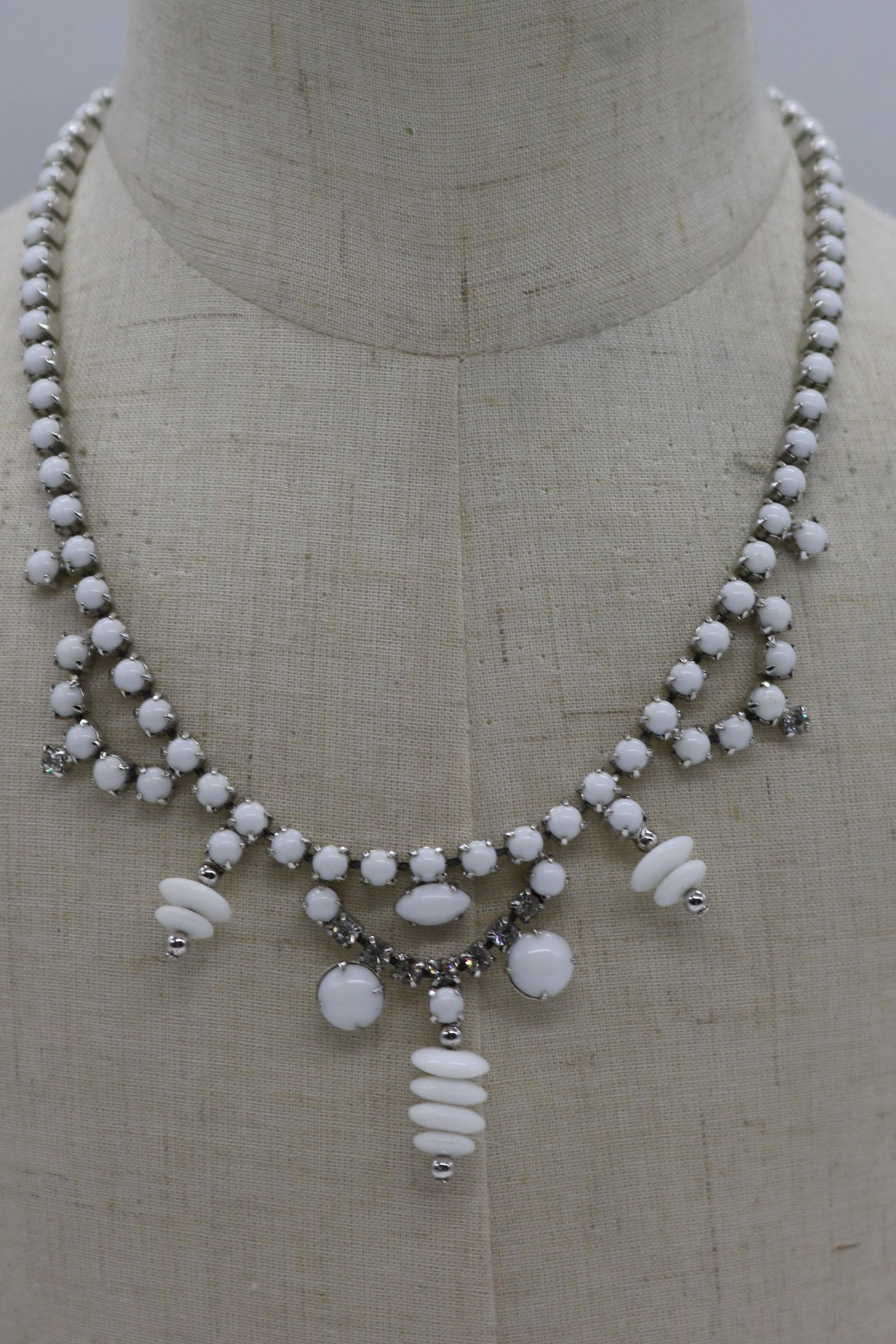 A vintage silver tone necklace of white milk glass (1 of 2)