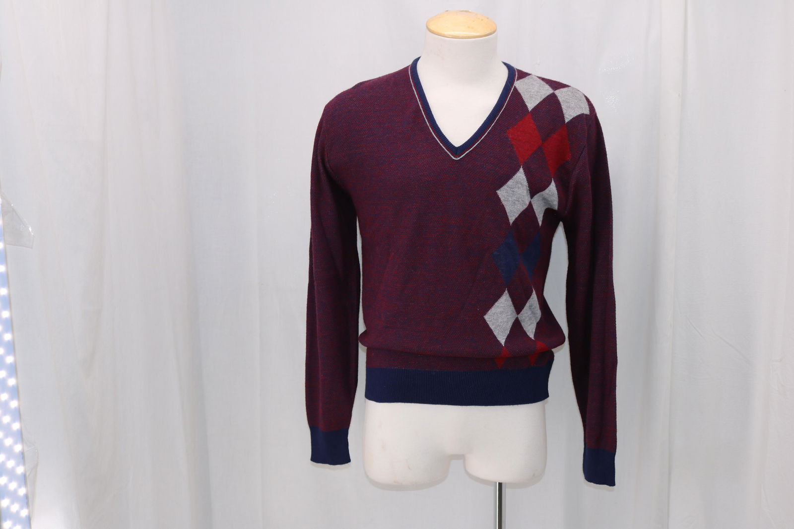 Vintage 1980's Men's Jantzen Argyle Wool Blend Sweater: V-neck, red white and blue wool blend with argyle print, marked size L, Approx. 44" Chest, good condition.