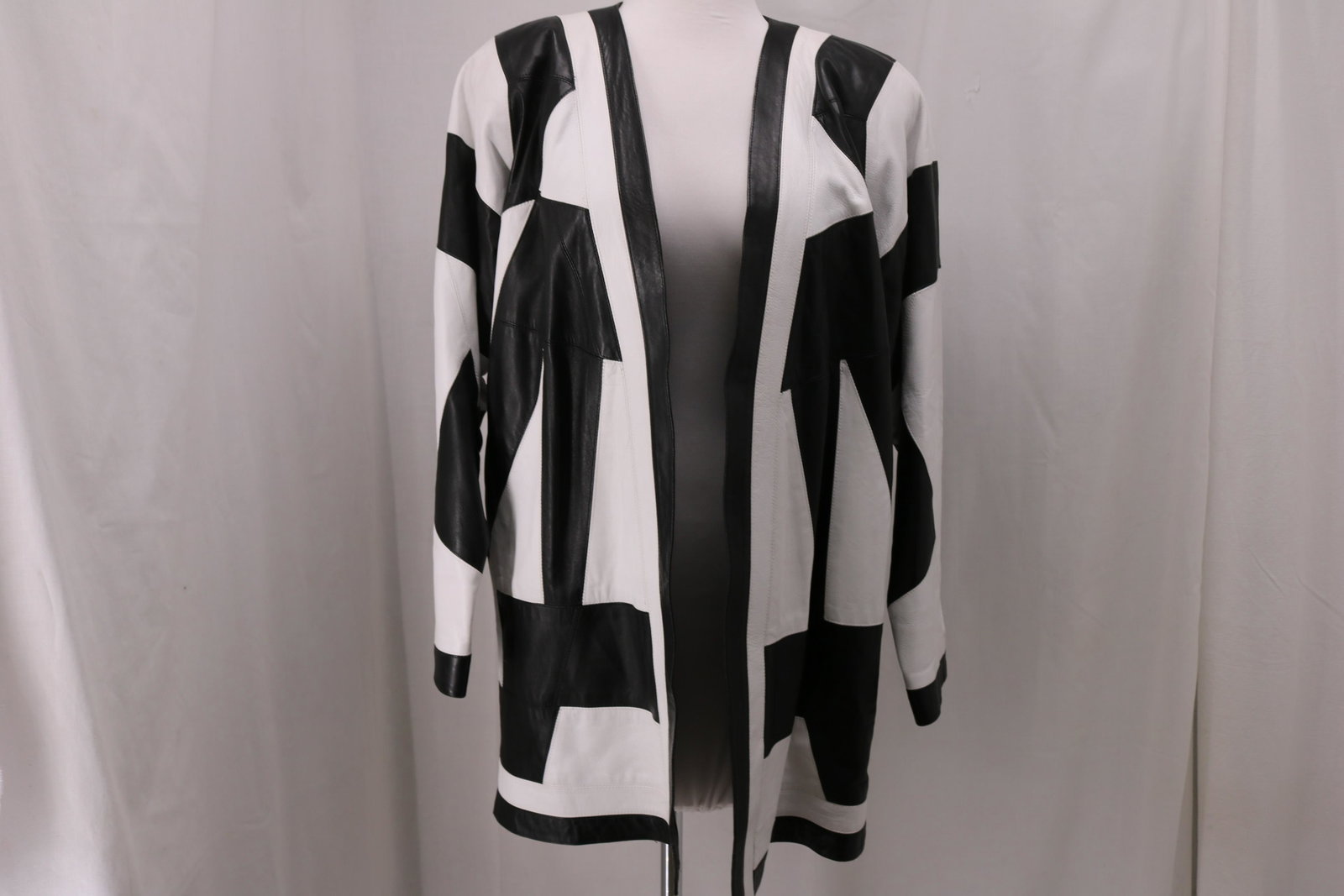 Vintage 1980's Ladies Suzanne Van Den Heurk Black &: funky black and white leather design, 100% silk lining, shoulder pads, clutch front, marked size S, Approx. 44" Bust, good condition.