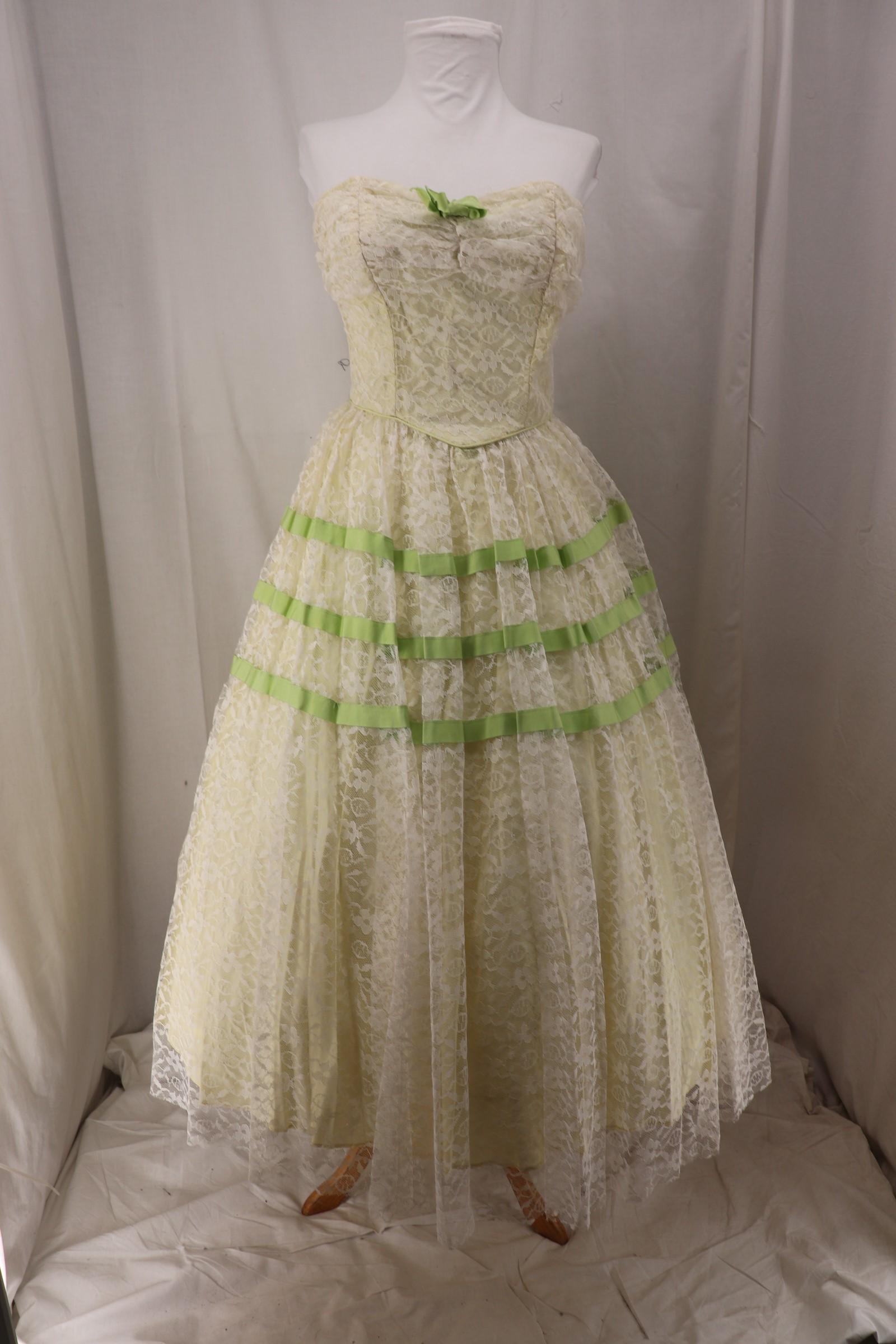 Vintage 1950's White Lace Party/Prom Dress: strapless, sweetheart neckline with ruched lace detail, green ribbon bow on front, boned bodice, shaped waistline, gathered white lace skirt with green ribbon detail, back metal zipper, Approx. 36" Bu