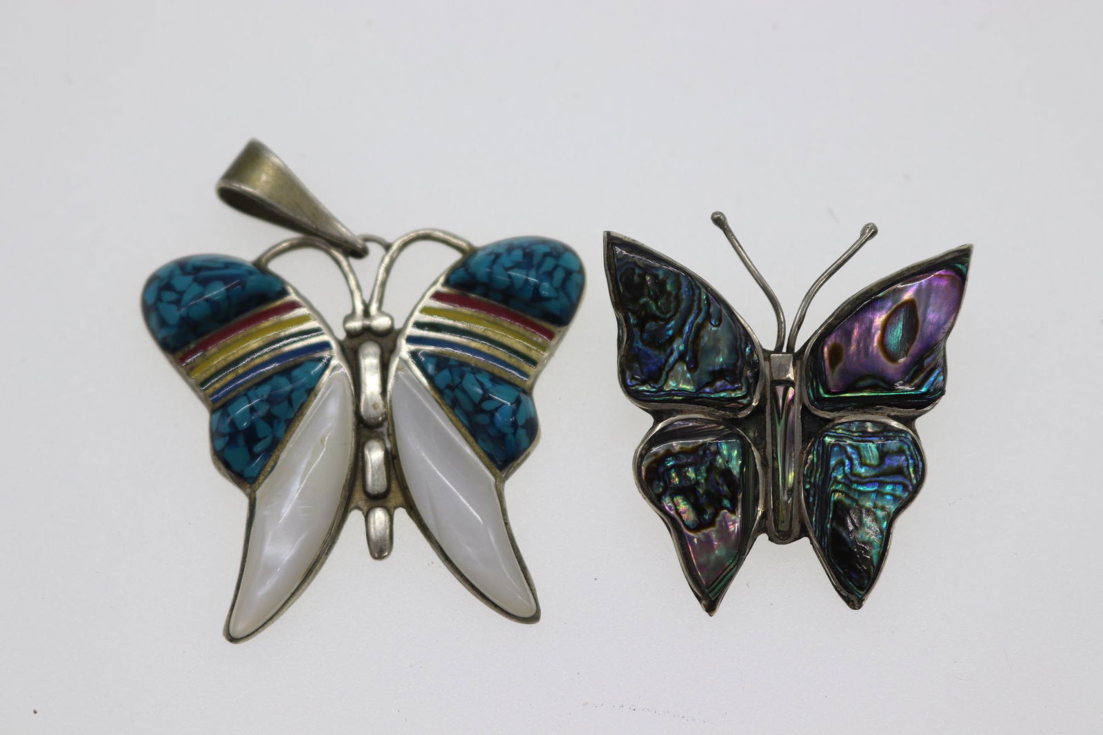 Lot of 2 Vintage Butterfly Brooch/Pendant: brooch says Alpaca Mexico, is silver with abalone detail, Approx. 1.5", Pendant is stamped Mexico, enamel rainbow detail & blue & white stone detail, Approx. 2", see photos.